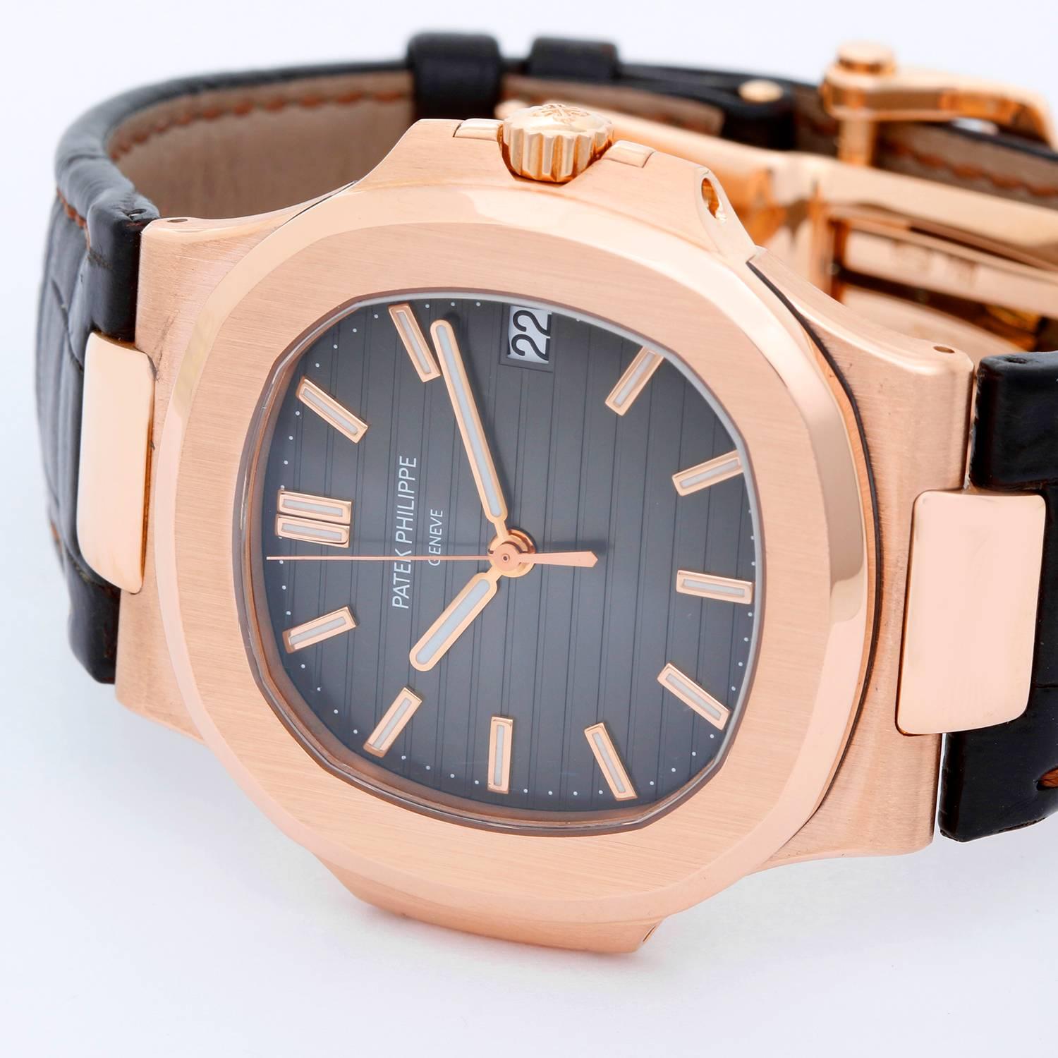 Patek Philippe & Co. Nautilus Men's 18k Rose Gold Watch 5711R-001 -  Automatic winding. 18k rose gold case (43mm) (43mm diameter). Brown dial. Leather strap band with 18k rose gold deployant clasp. Pre-owned  with box and papers.