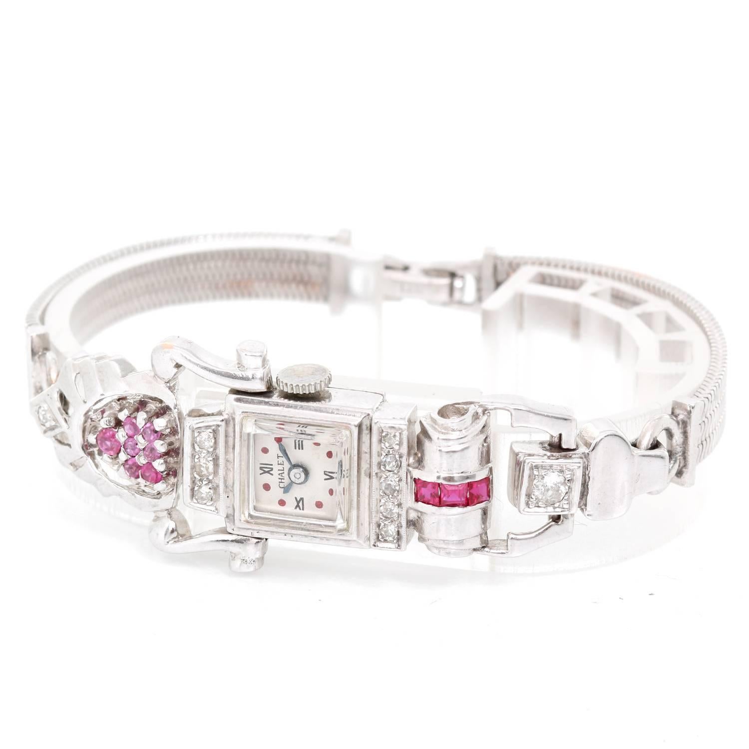 Vintage Chalet Ruby Ladies Watch -  Manual winding. 14K White gold  ( 13 x 13 mm ) with .09 cts round brilliant cut. Near colorless.. White dial with blued steel hands. 14K White gold strap with synthetic Ruby weighing .72cts. Pre-owned with custom