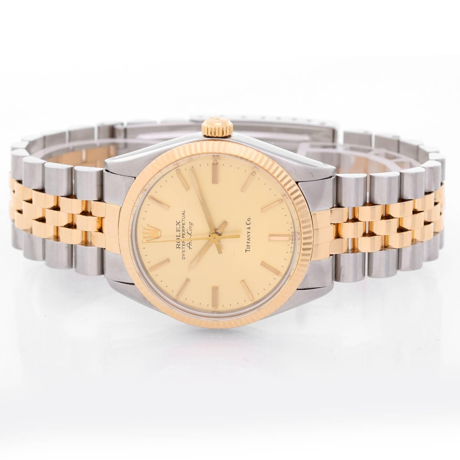 Rolex Air-king  Retail by Tiffany & Co.  Two- Tone Watch 5501 -  Automatic. Stainless Steel ( 34 mm ). Champagne dial with stick hour markers; Tiffany & Co logo on dial. Jubilee bracelet. Pre-owned with Tiffany & Co. box and books.