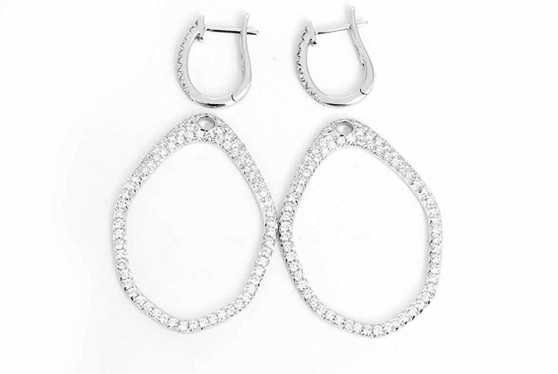 These beautiful 18k white gold earrings feature 2.03 carats of very white SI1 clarity, H-color diamonds. These earrings are versatile and can be worn with or with out the dangling hoop. The earrings measure apx. 2-inches in length and 5/8-inch in