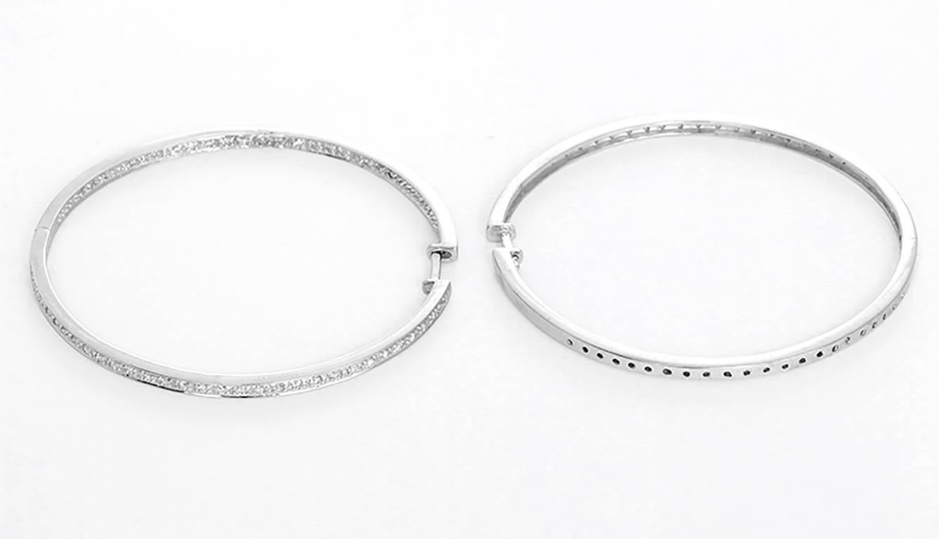 These amazing inside-out hoop earrings feature apx. 1.2 carats of diamonds set in 14k white gold. Earrings measure apx. 2-inches in diameter. Total weight is 14.3 grams. These hoops are great for everyday as well as dress!