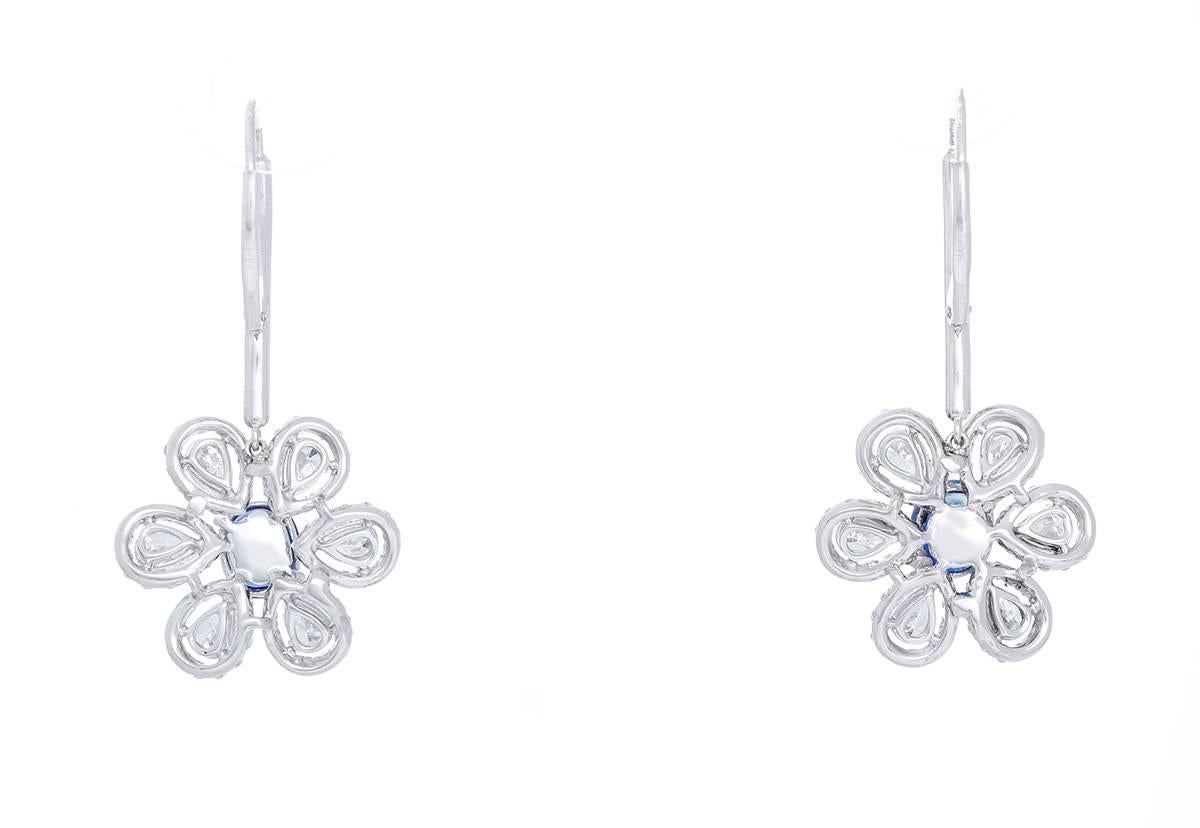These  flower pendant earrings feature 2.81 cts. of sapphires, 2.21 cts. of pear shaped diamonds, and 1.36 cts. of round diamonds suspended on a 0.20 ct. diamond dangle. Flower pendants measure apx. 3/4-inch in diameter. Earrings measure apx. 1-1/2