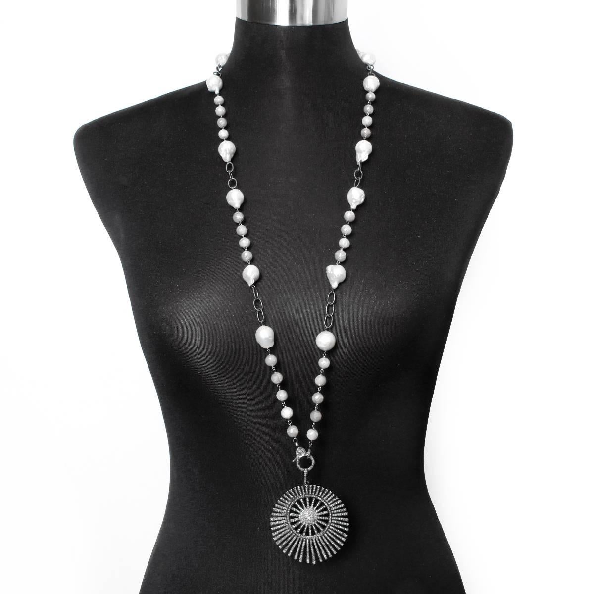 This bohemian necklace features a sunburst pendant and diamond clasp; both set in oxidized silver on a grey moonstone and freshwater pearl chain. Pendant including clasp measures apx. 3-1/4 inches in length on apx. a 34-inch chain. Total weight is