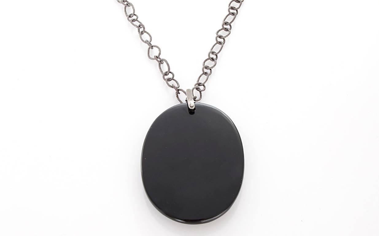 This boho inspired necklace features a diamond and onyx pendant on an oxidized sterling silver chain. Pendant measures apx. 2-inches in width and apx. 3-inches in length including bale. Chain measures apx. 34-inches in length. Total weight is 66.6