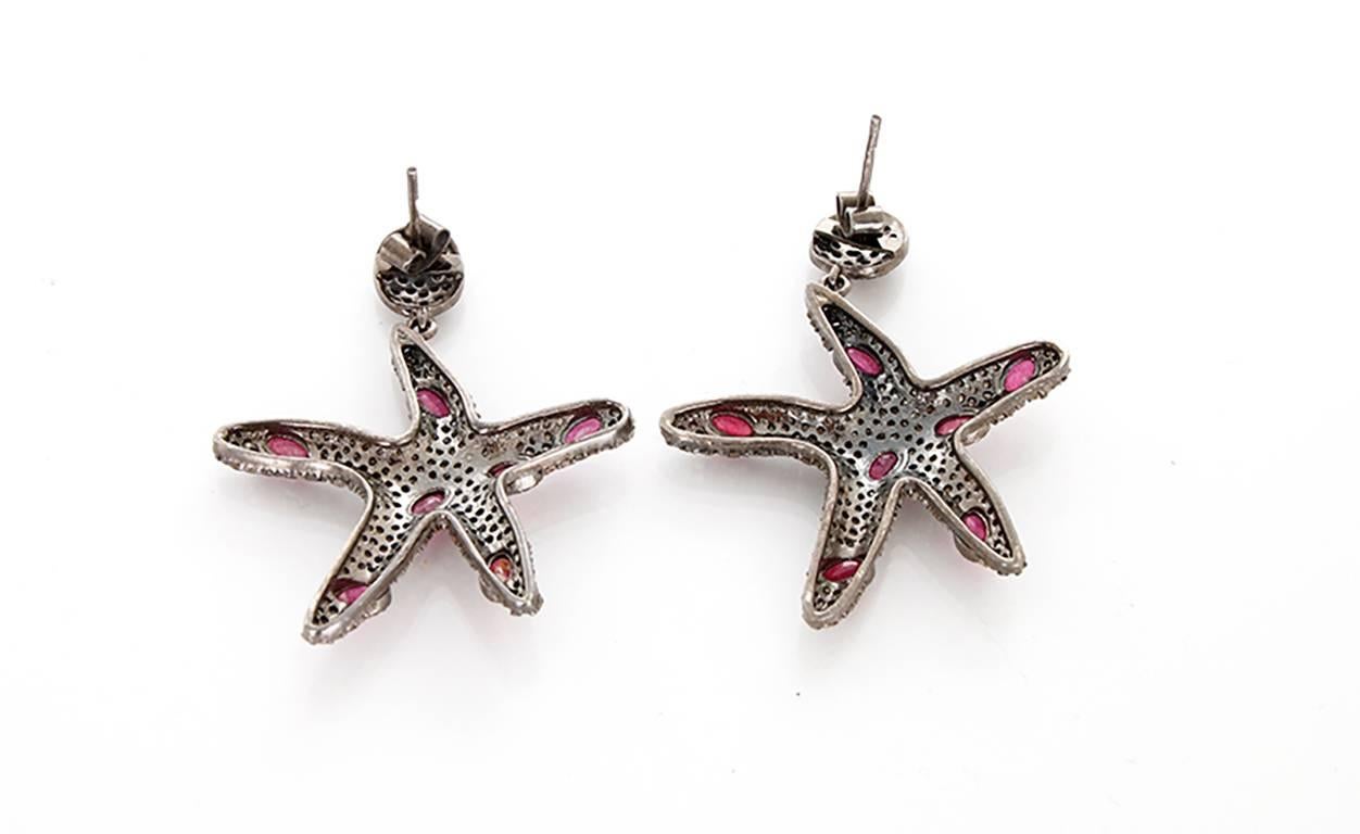 These beautiful earrings feature rubies and 4.07 cts of  diamonds set in oxidized sterling silver. Earrings measure apx. 2-inches in length.  Total weight is 15.8 grams.
