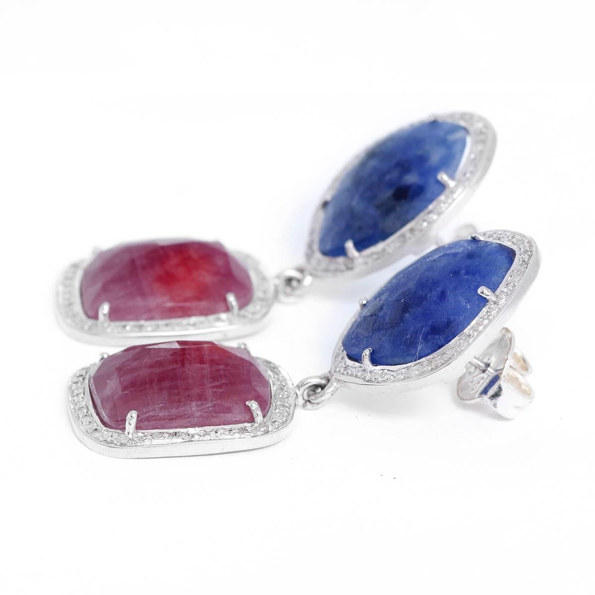 These bohemian inspired earrings feature sapphires and 1 ctw. of diamonds set in silver. Total weight is 16.1 grams. Earrings measure apx. 2-inches in length.