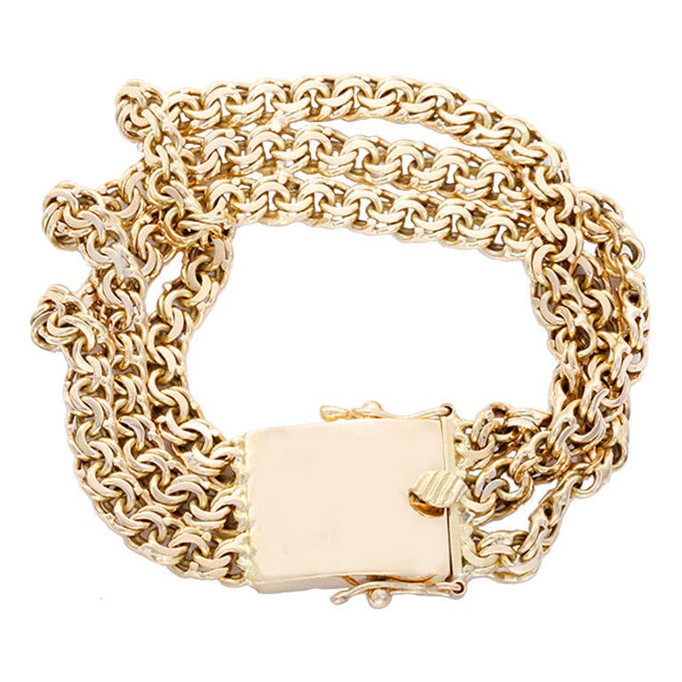 This chic bracelet consists of three strands of a double fancy link chain with an oversized box link clasp. It is apx. 7-1/2 inches in length with a total weight of 54.0 grams. Stamped 18K.  This bracelet is perfect for any look!