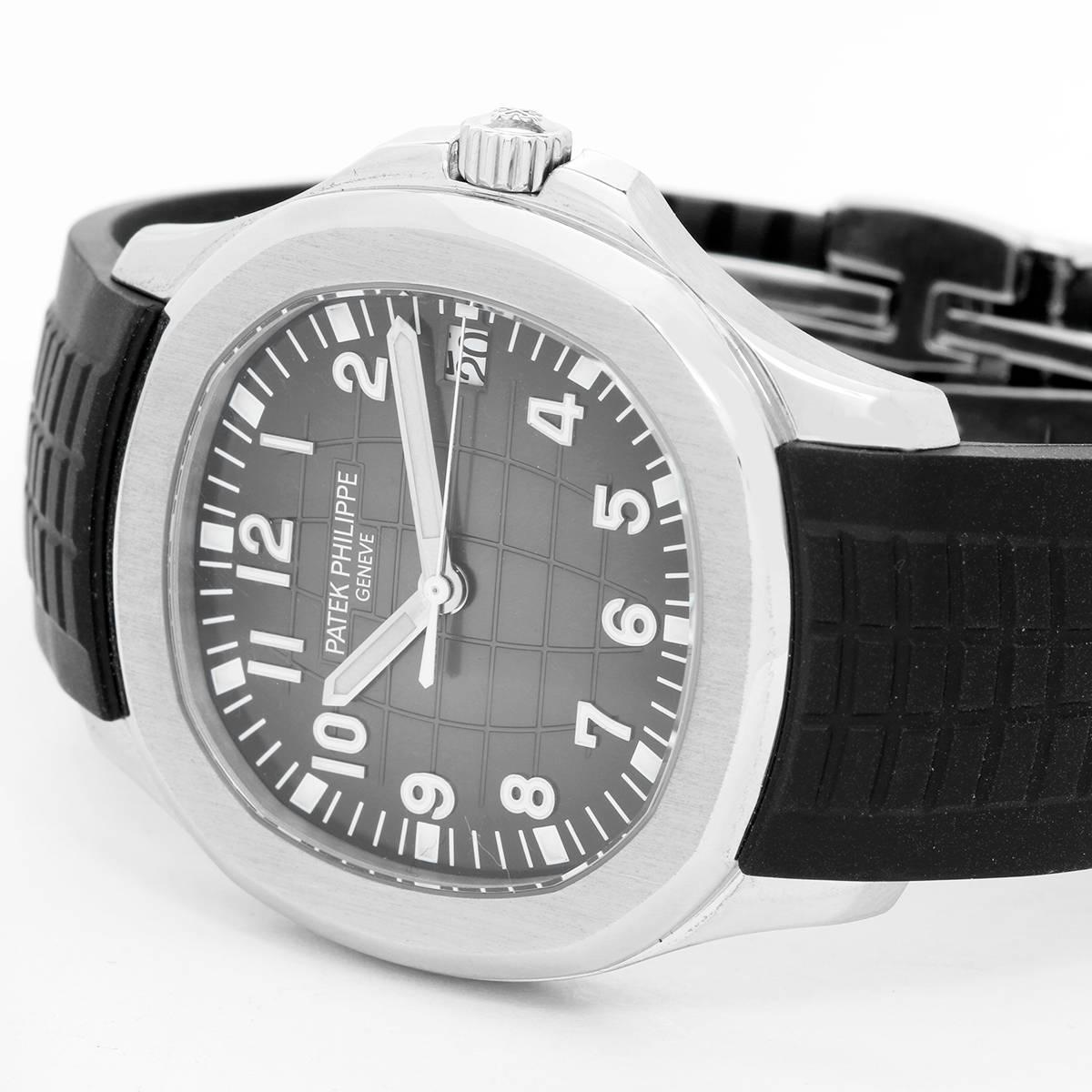 Patek Philippe Aquanaut Men's Stainless Steel 
Watch 5167A-001 - Automatic winding. Stainless steel case with exposition back (40mm diameter). Black dial with Arabic numerals and luminous markers. Black rubber strap band with stainless steel Patek