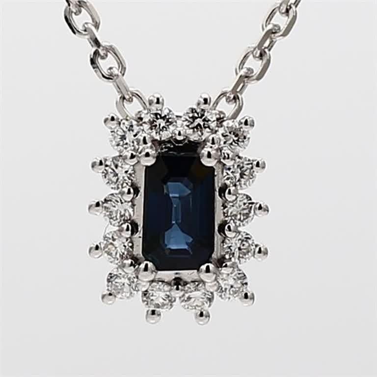 RareGemWorld's classic sapphire pendant. Mounted in a beautiful 14K White Gold setting with a natural emerald cut blue sapphire. The sapphire is surrounded by natural round white diamond melee in a beautiful flower shape. This pendant is guaranteed