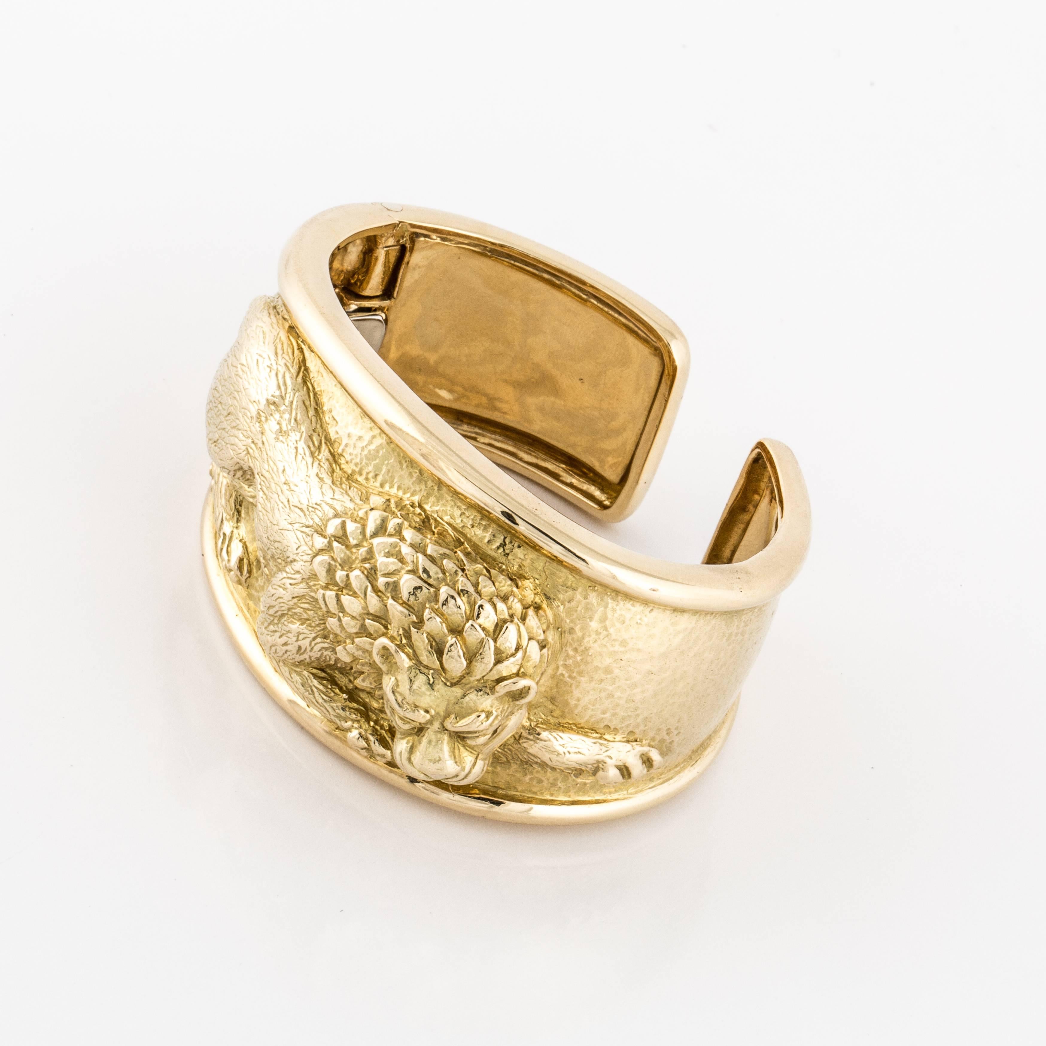 Classic David Webb bracelet depicting a lion.  The cuff is hinged at the side and the oval opening is 2-1/4".  Top of bracelet measures 1.5" and it tapers to 1.0" at the back.  Stands 3/4" tall.  Marked on the inside "Webb