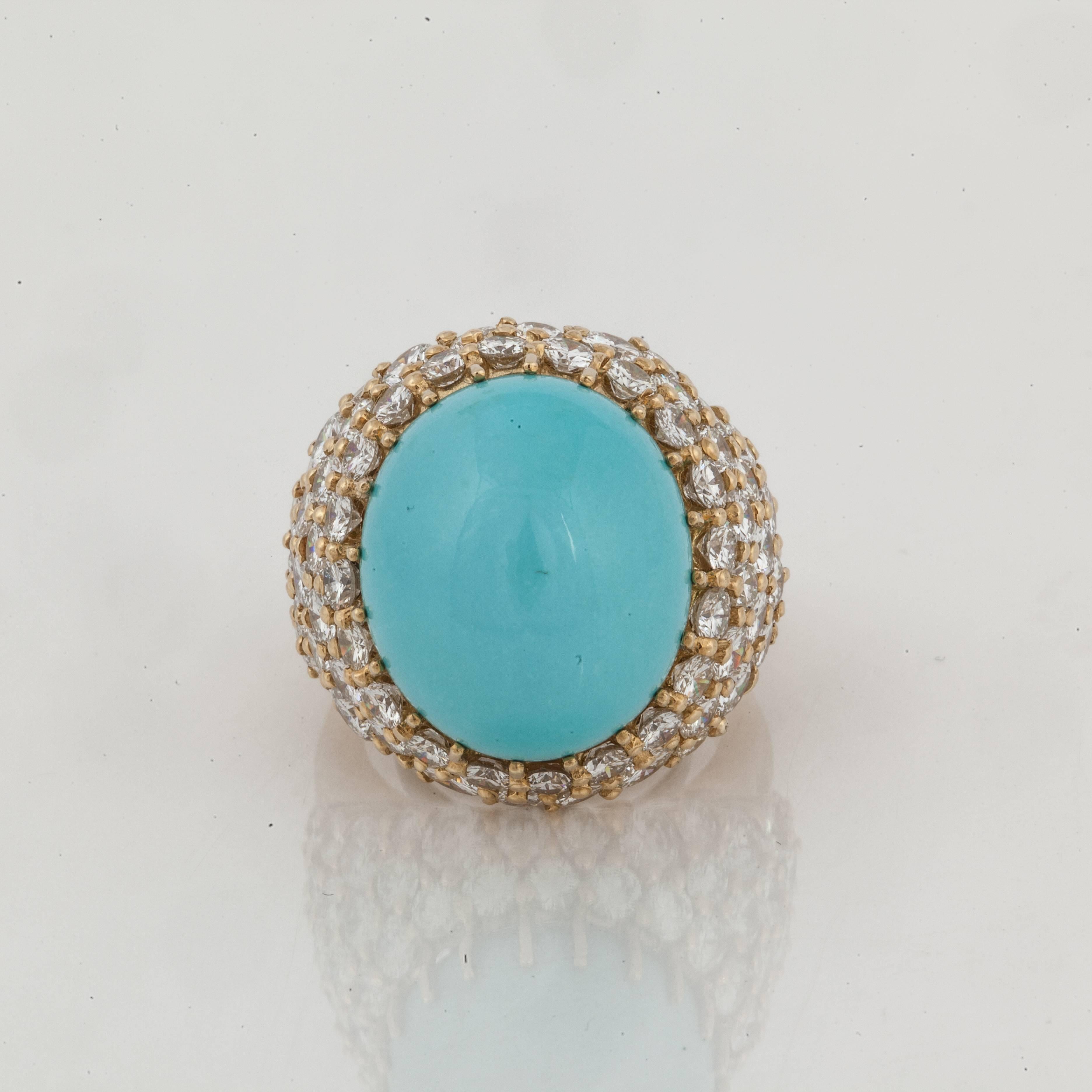 18K yellow gold featuring a large cabochon turquoise stone weighing 33 carats with72 round diamonds that total 11 carats, F-G color and VS1-2 clarity.  Presentation area is 1 inch by 1 inch and it stands 7/8 inches off the finger.  Currently a size