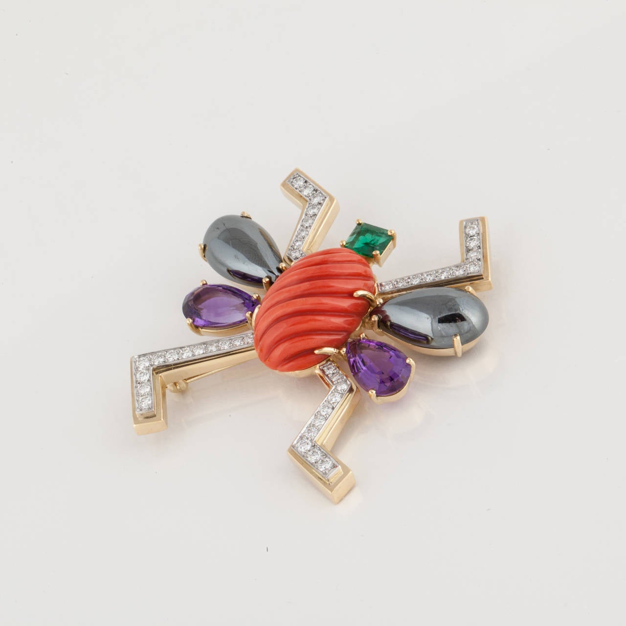 Paloma Picasso for Tiffany 18K yellow gold bug pin.  Body is comprised of an emerald, hematite, amethyst, red coral and diamonds.  Dated 1988.  Inscribed on back 