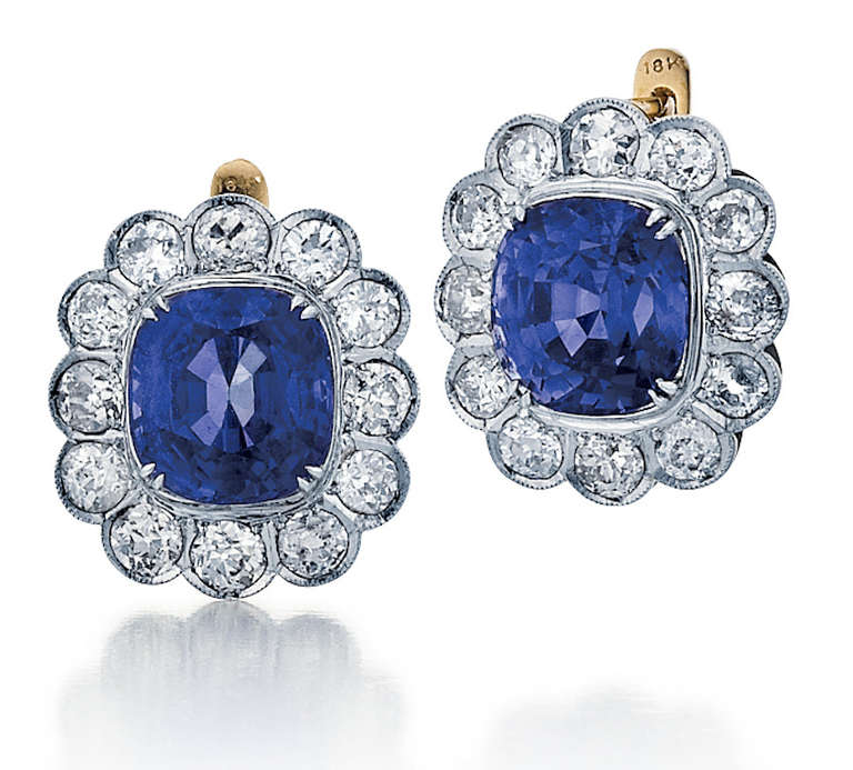 Earrings composed of 18K yellow gold and platinum featuring two cushion-cut blue sapphires framed by round diamonds.  The sapphires weigh 5.93 carats and 5.85 carats, accompanied by an AGTA report stating they are natural Burmese, no heat. 
