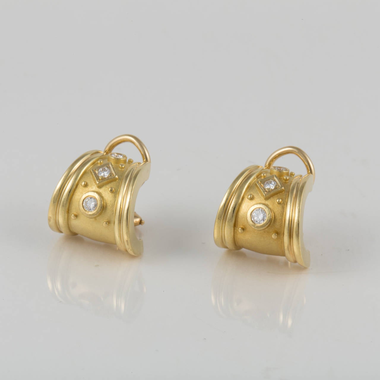 Yellow gold earrings by SeidenGang crafted in 18K.  From their Classic Collection, these earrings feature bezel set diamonds totaling 0.30 carats. They have Omega backs.  Hallmarked 