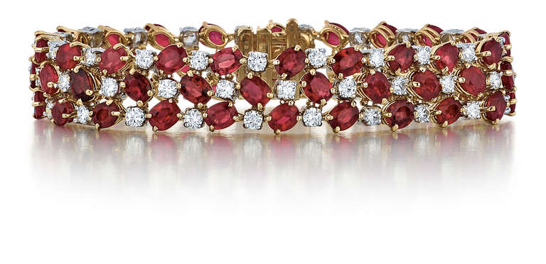 Oscar Heyman & Brothers bracelet composed of 18K yellow gold with oval rubies and round diamonds.  The rubies total 35.73 carats and round brilliant-cut diamonds that total 5.18 carats, E-F color and VVS1 clarity.  The bracelet measures 7 1/2 inches