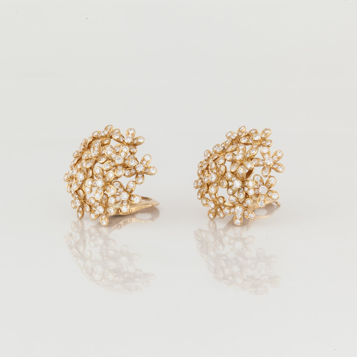 Van Cleef and Arpels 18K yellow gold earrings from the Socrate collection.  The earrings feature 264 round diamonds totaling 7.02 carat,  F-G color and VVS-VS clarity.  They are marked 