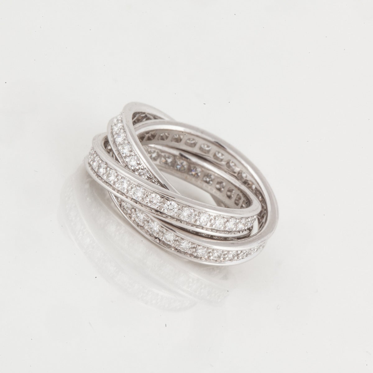 Cartier Trinity ring in 18K white gold with diamonds.  The ring features ninety three (93) round diamonds totaling 2.25 carats,  F-G color and VVS-VS clarity.  The ring is a European size 51 or US 5 1/2.  It is marked on the outside edge 
