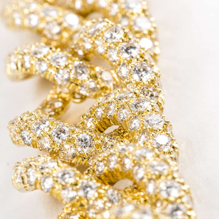 This 18kt yellow gold necklace by Henry Dunay has 1,947 diamonds that weigh approximately 75.0 carats total weight. They are F-H in color and VVS-VS in clarity. The necklace is 16