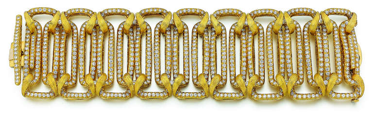 This wide bracelet by Henry Dunay is in 18kt yellow gold. There are 700 round diamonds that weigh 28.0 carats total weight. The bracelet is  2 inches wide and 7 inches long.