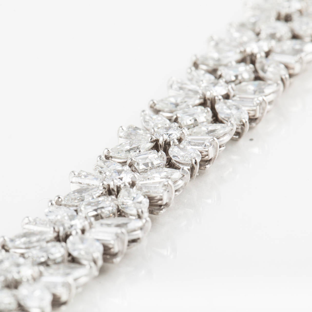 Mid-Century Cartier platinum diamond bracelet with mixed-cut diamonds.  There are  sixty-four (64) marquise shaped diamonds, fifteen (15) round diamonds, sixteen (16) square cut diamonds and thirty-two (32) baguette diamonds for a total diamond