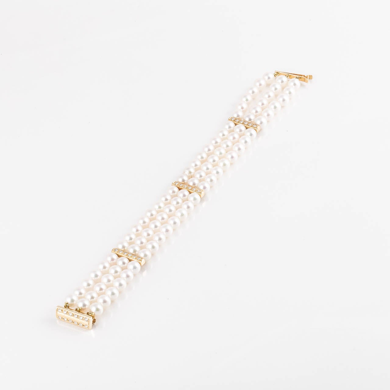 Beautiful three-strand cultured pearl bracelet.  Made by Mikimoto with the clasp showing the 