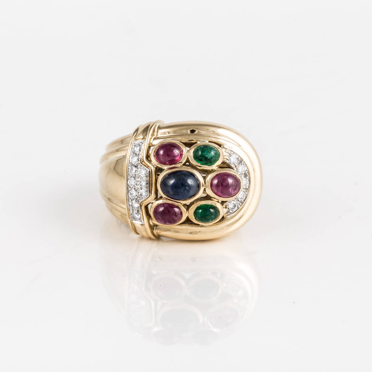 David Webb ring composed of 18K yellow gold with cabochon rubies, emeralds, a sapphire and round diamonds. There are fifteen round diamonds that total 0.35 carats, F-G color and VS clarity.  The ring is marked 