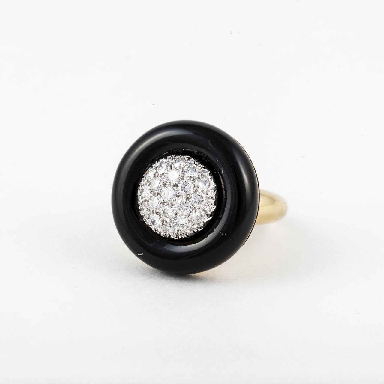 Estate ring in 18K yellow gold featuring a black onyx disc with pavé diamonds in the center.  Ring is marked 