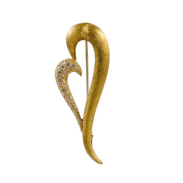 This stylized heart pin is by Henry Dunay. It is in 18kt yellow gold, with 60 round brilliant-cut diamonds that weigh 1.47 carats total weight.