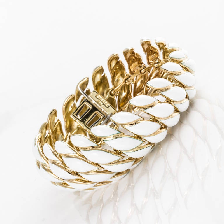David Webb 18K yellow gold bracelet with white enamel.  The length measures 8 inches.