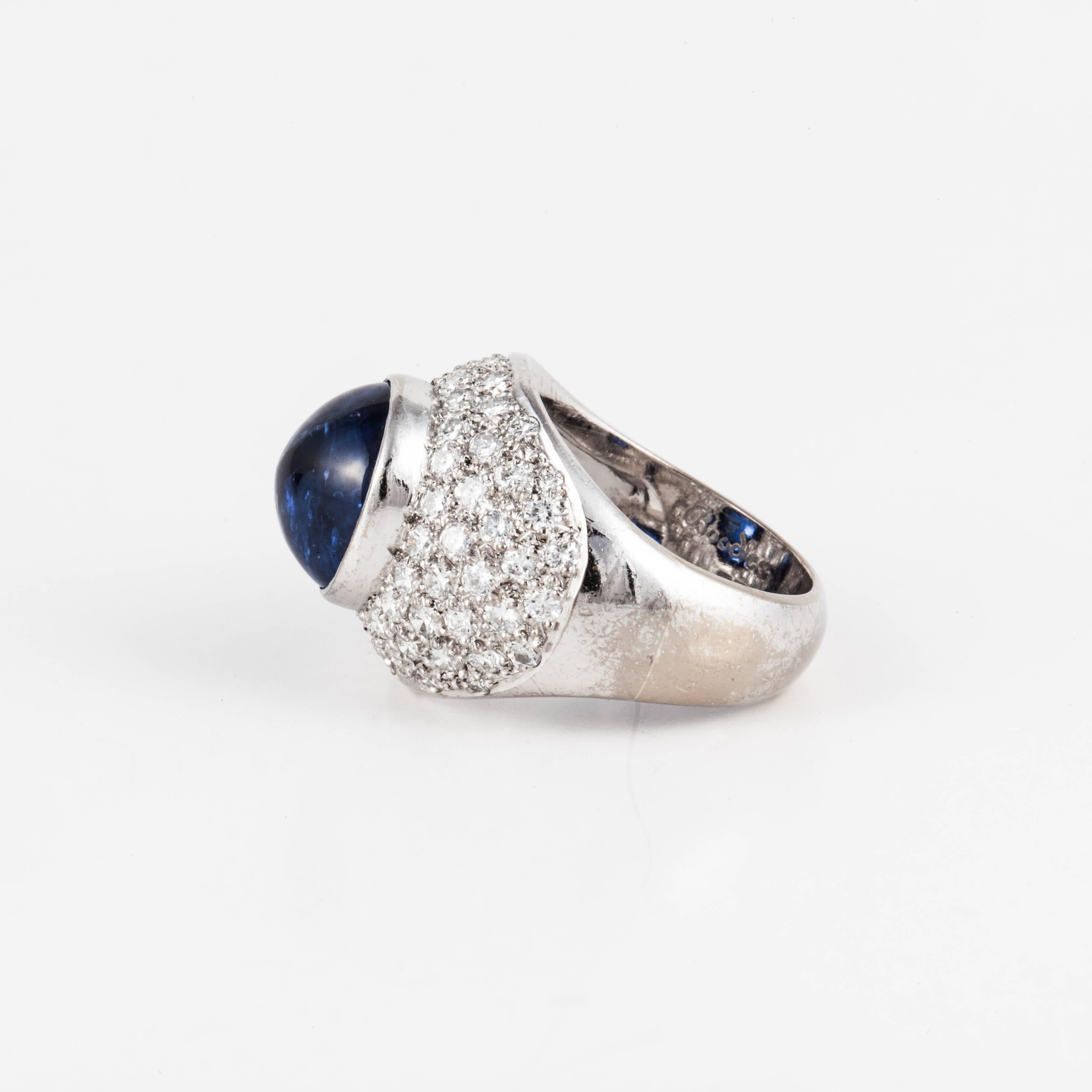 Estate 'Boodles' ring in 18K white gold ring featuring a cabochon blue sapphire with round brilliant-cut diamonds.  There are 72 round diamonds that total 1.50 carats, G-H color and VS clarity.   The cabochon blue sapphire is 8.40 carats.  The