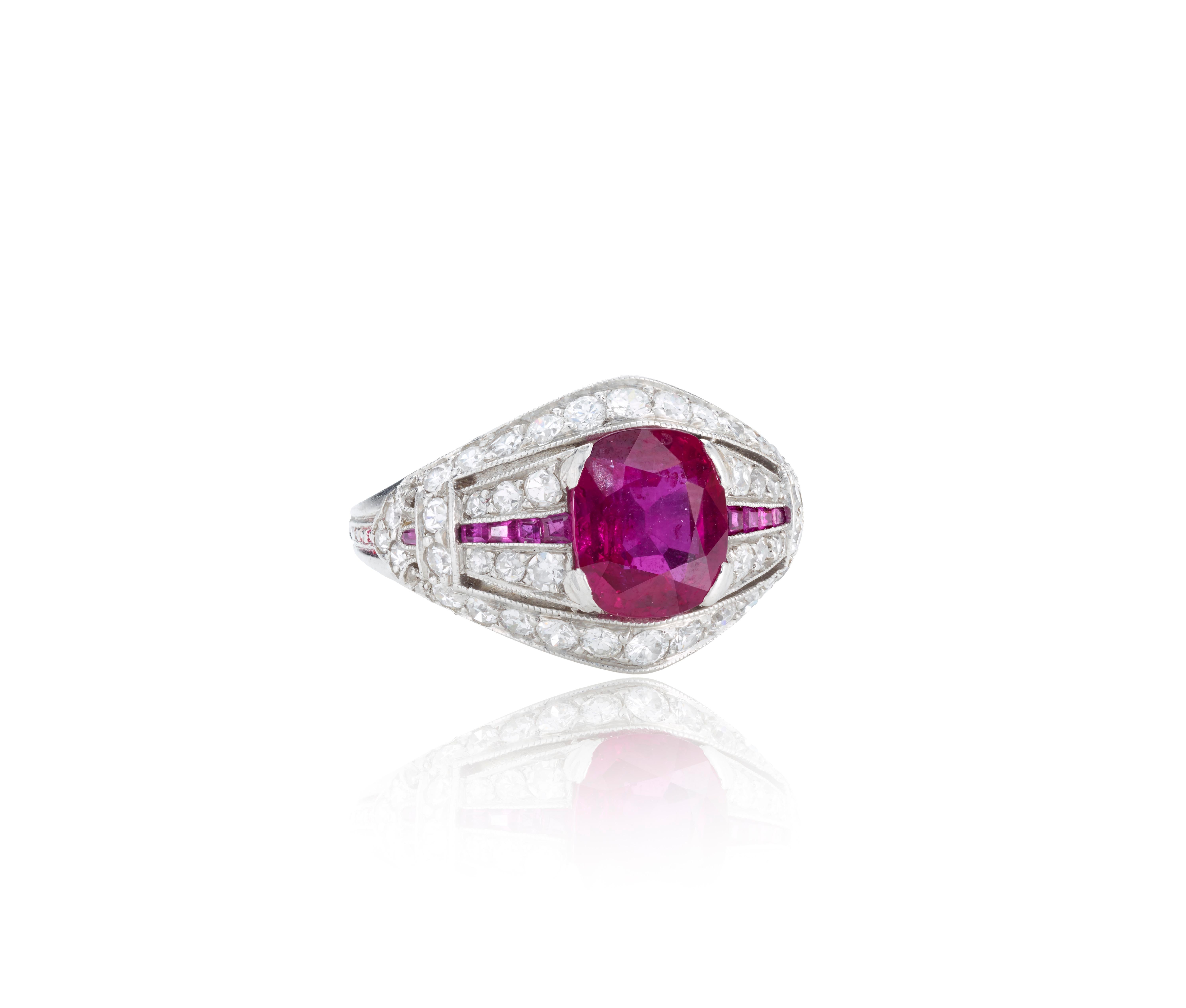 An Art Deco platinum and ruby and bead-set diamond ring with calibré-cut rubies, circa 1930.

Ring contains one cushion-cut medium-dark, vivid red ruby (total carat weight: 1.97 carats), 44 single cut diamonds (total carat weight: 1.10 carats,