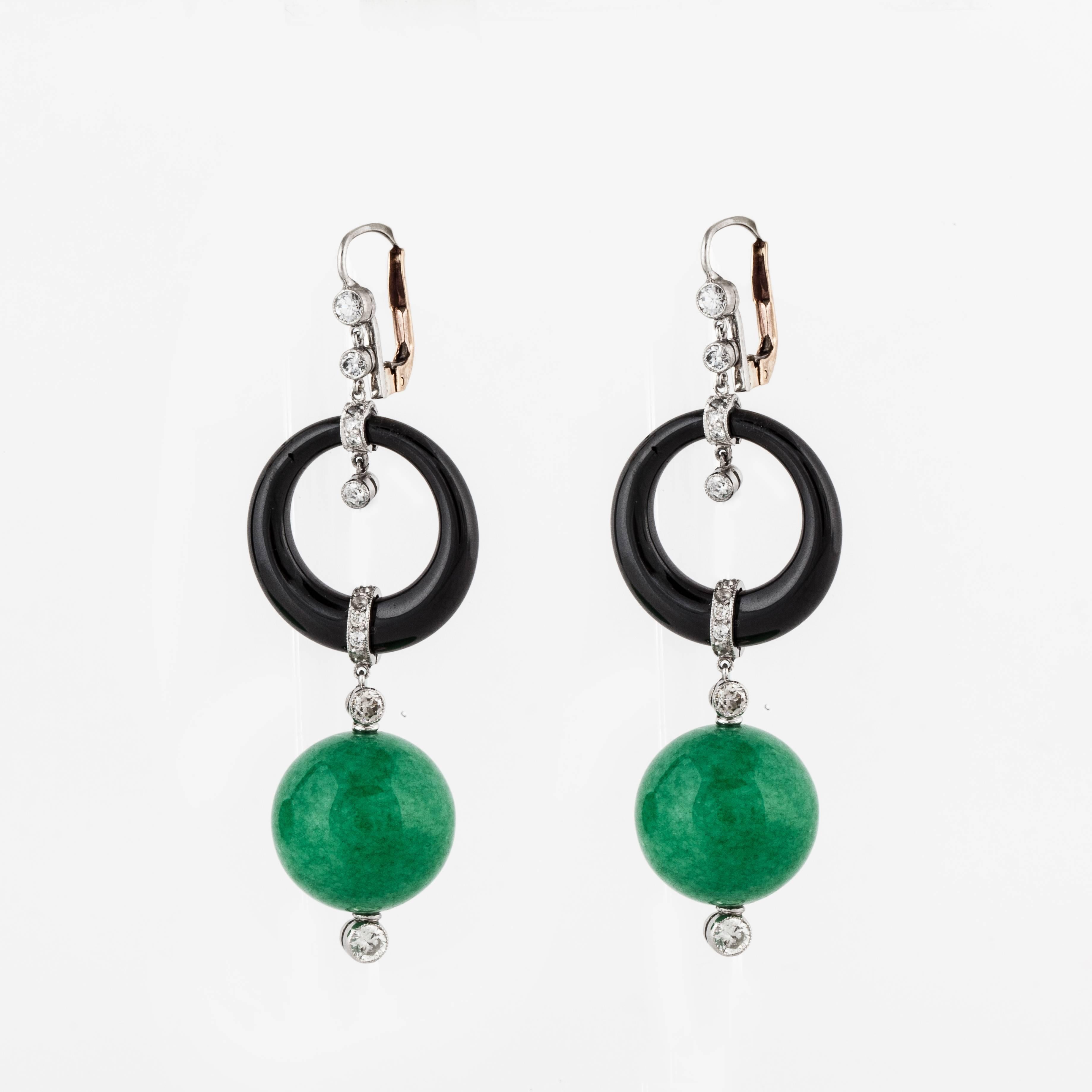 18K white gold drop dangle earrings composed of jade beads, onyx discs, and diamonds in platinum with 18K lever backs.  There are two jade beads that measure 16.1 mm each suspended from onyx discs. There are twenty-six round diamonds that total 1.10