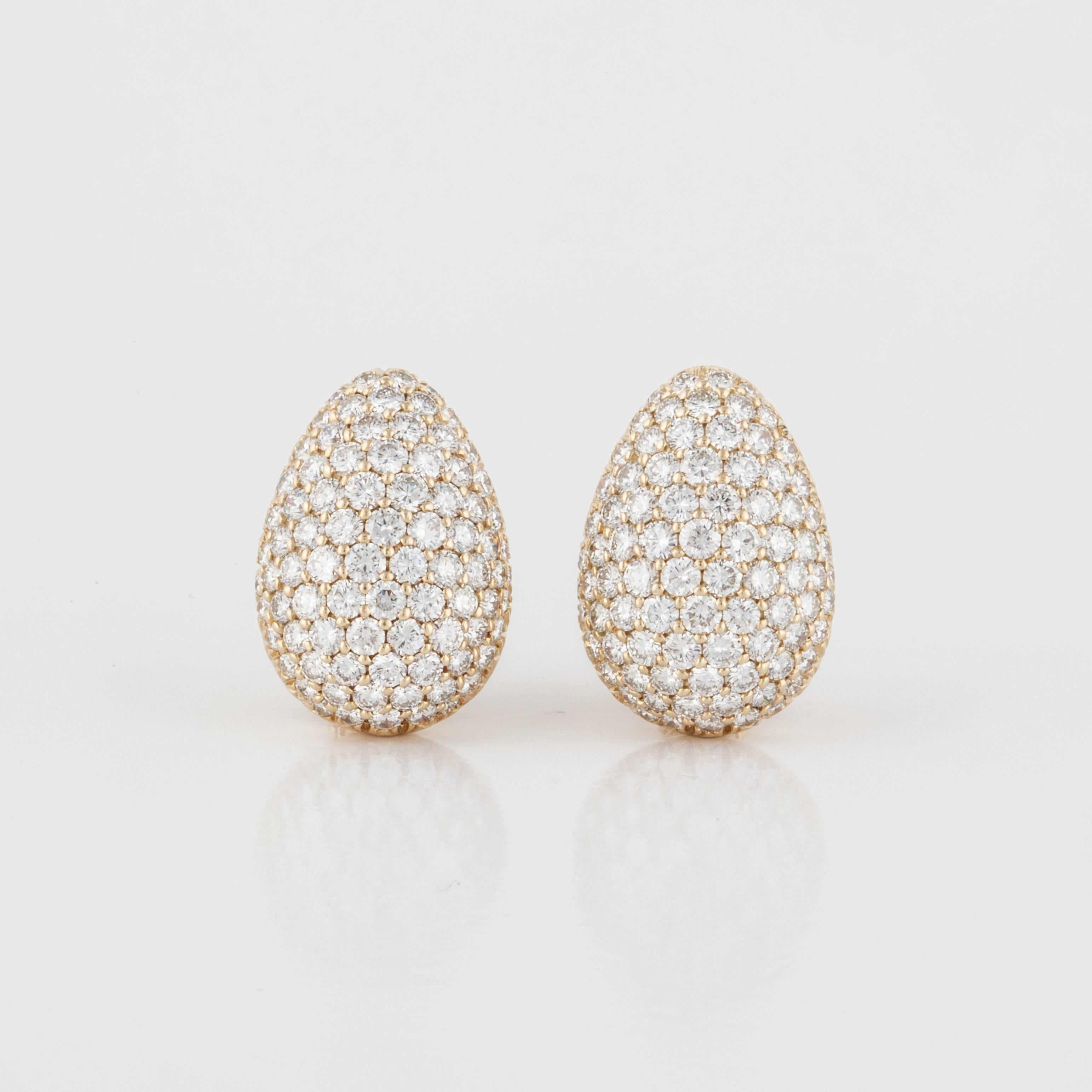 Pair of pear shape pavé diamond earrings in 18K yellow gold.  Earrings are marked 