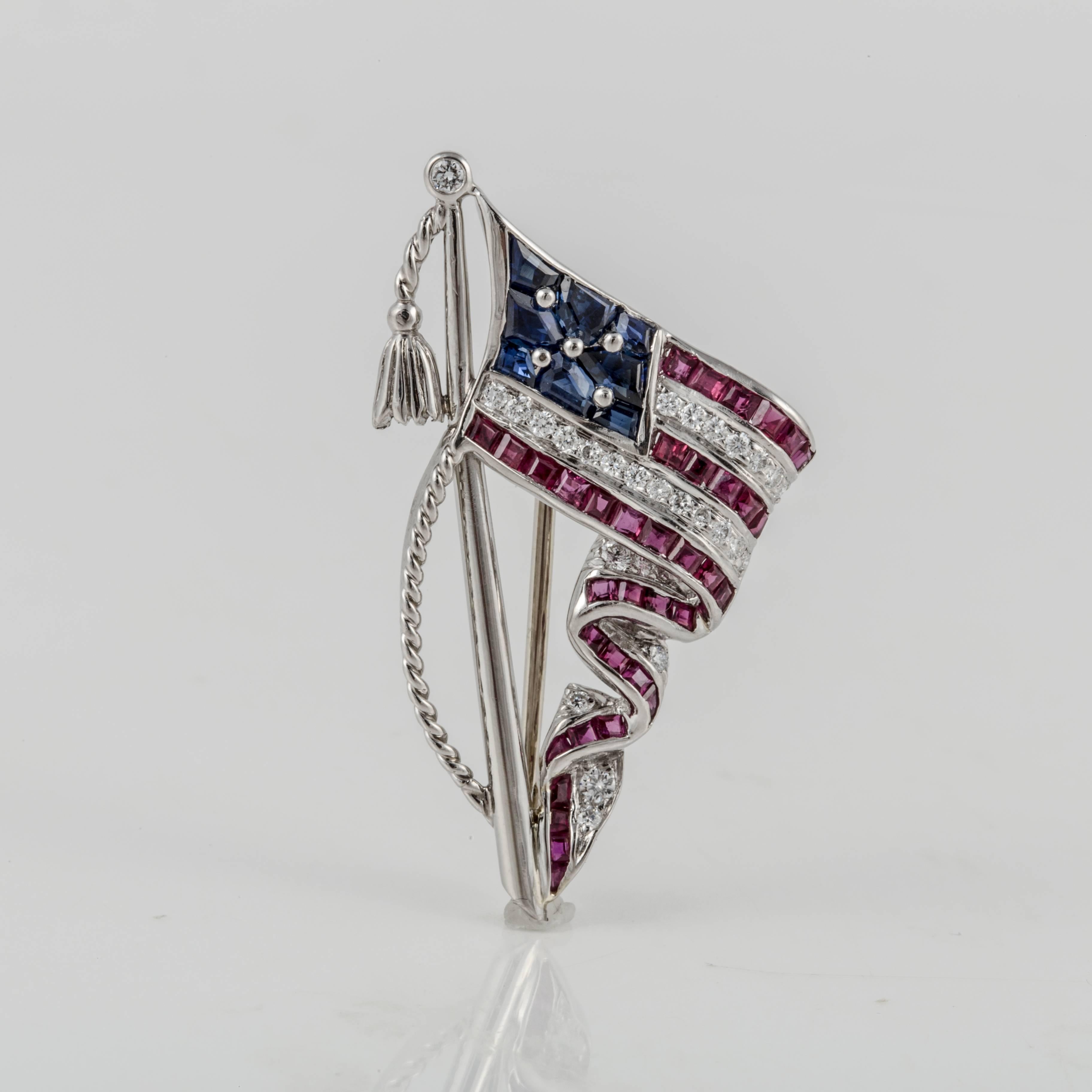 Oscar Heyman flag pin in platinum with sapphires, rubies and diamonds.  Marked 