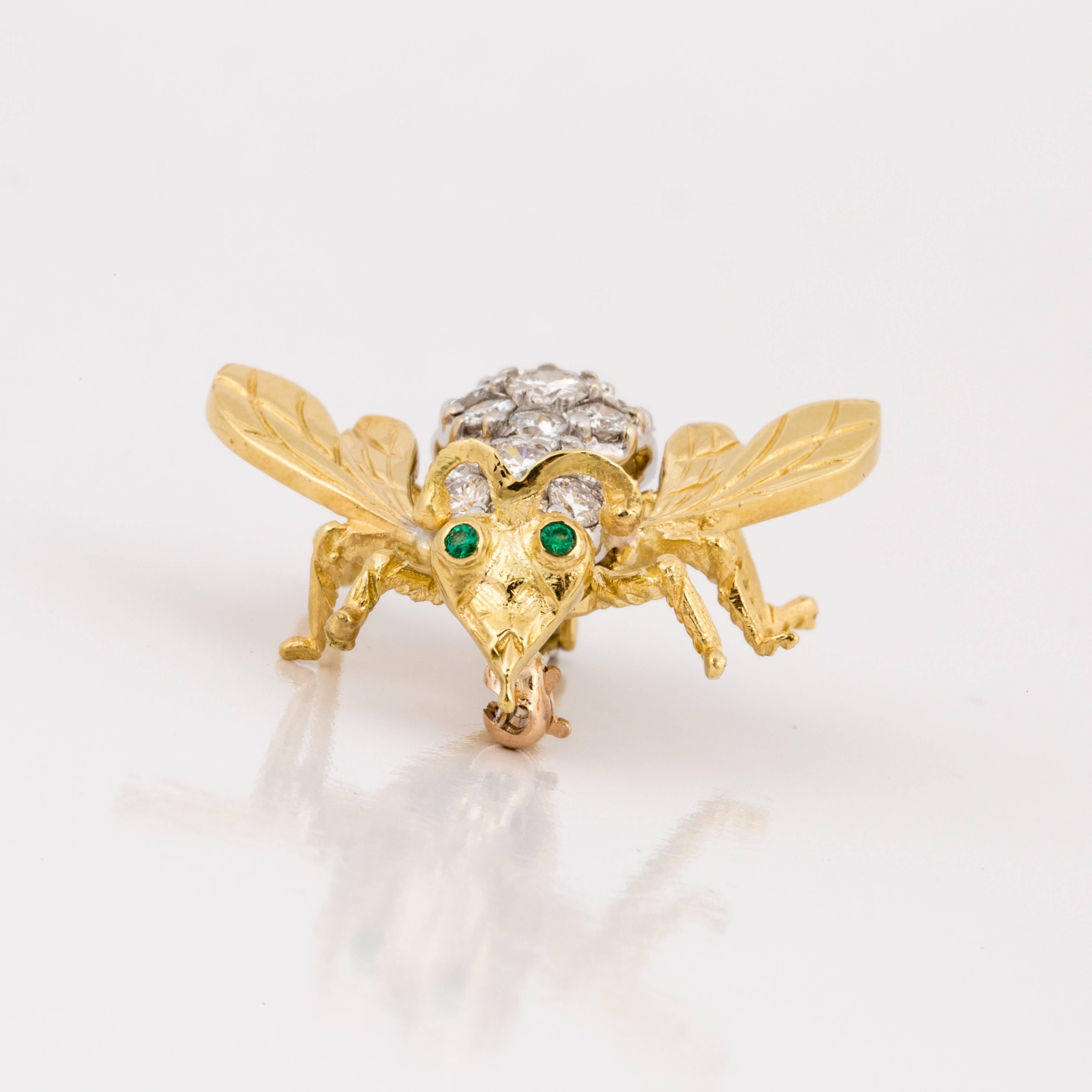 18K yellow gold pin depicting a bee with pavé round diamonds and cabochon emerald eyes.  The back is encrusted with 24 diamonds that total 1.60 carats, H-I color and SI2 clarity.   Pin measures 1 inch long and 1 1/8 inches wide.
