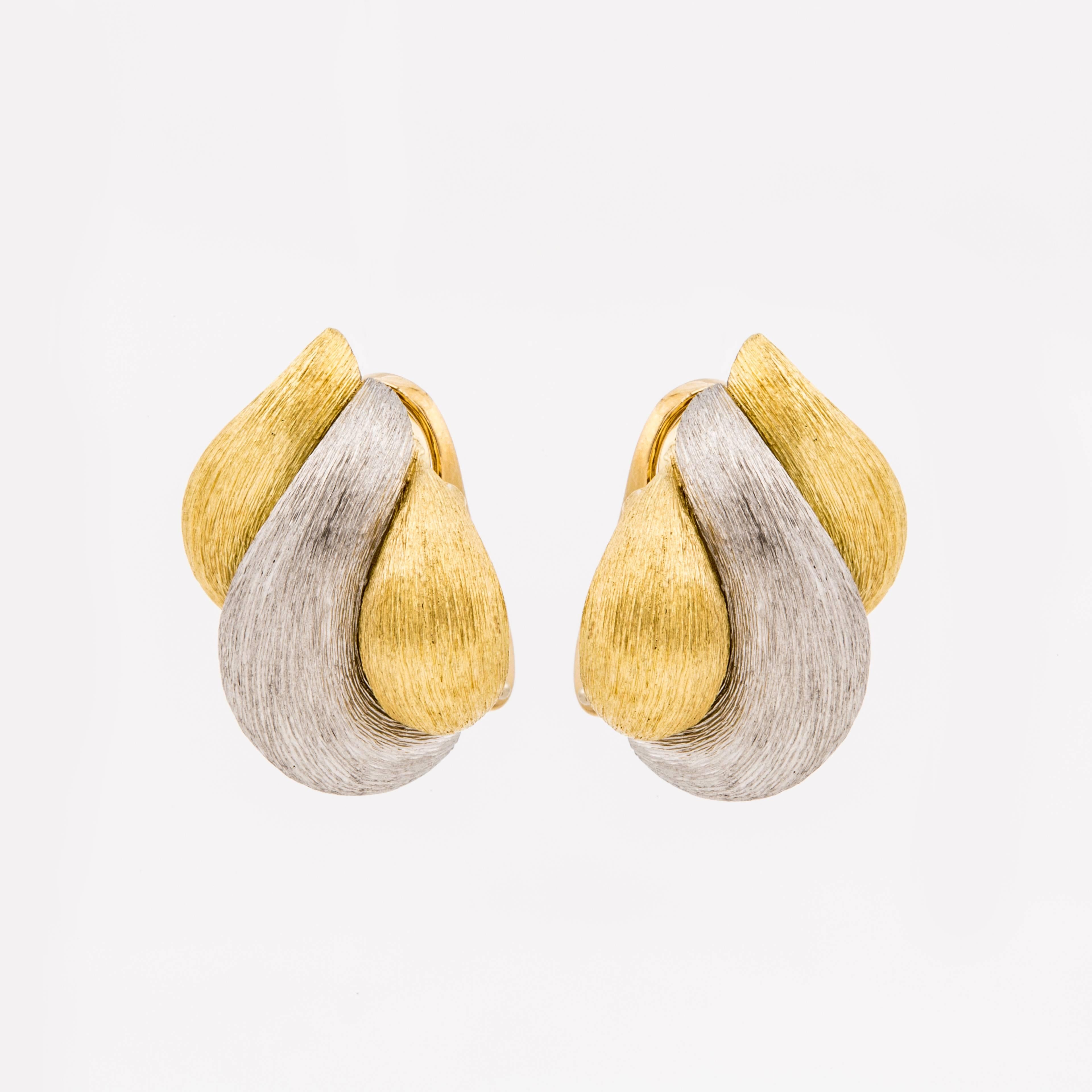 Henry Dunay 18K two tone Sabi finish earrings.  Marked on the back "750 HD A2996 5% Plat".  Graceful swirl design with clip backs.  Earrings measure 7/8" long and 3/4" wide.