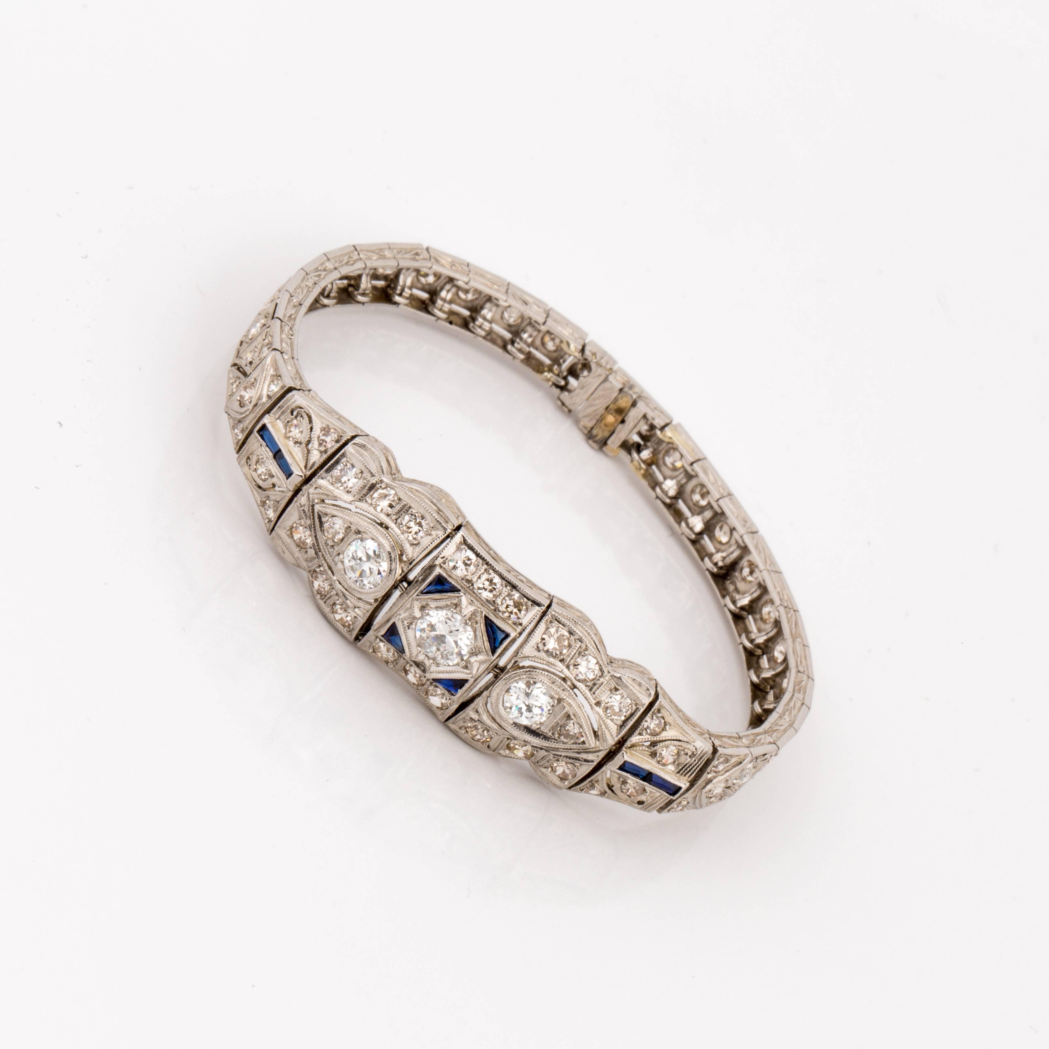 Art Deco openwork design bracelet in platinum with diamonds accented by synthetic sapphires.  There are a total of 65 diamonds that total 3.30 carats, J-L color and SI1-I1 clarity.  It measures 6 1/8 inches long and 1/2 inch wide.  Circa 1930.