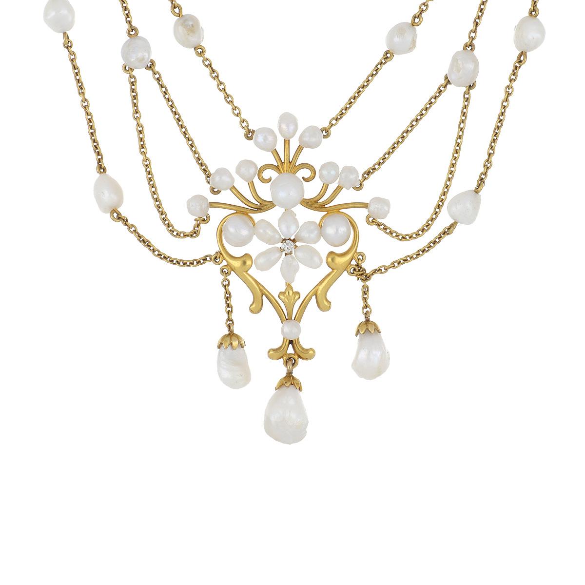 Art Nouveau 14K yellow gold floral swag necklace.  There are 3 florets each centered with diamonds and freshwater pearls.  The necklace measures 15 3/4 inches in length. Circa 1900.