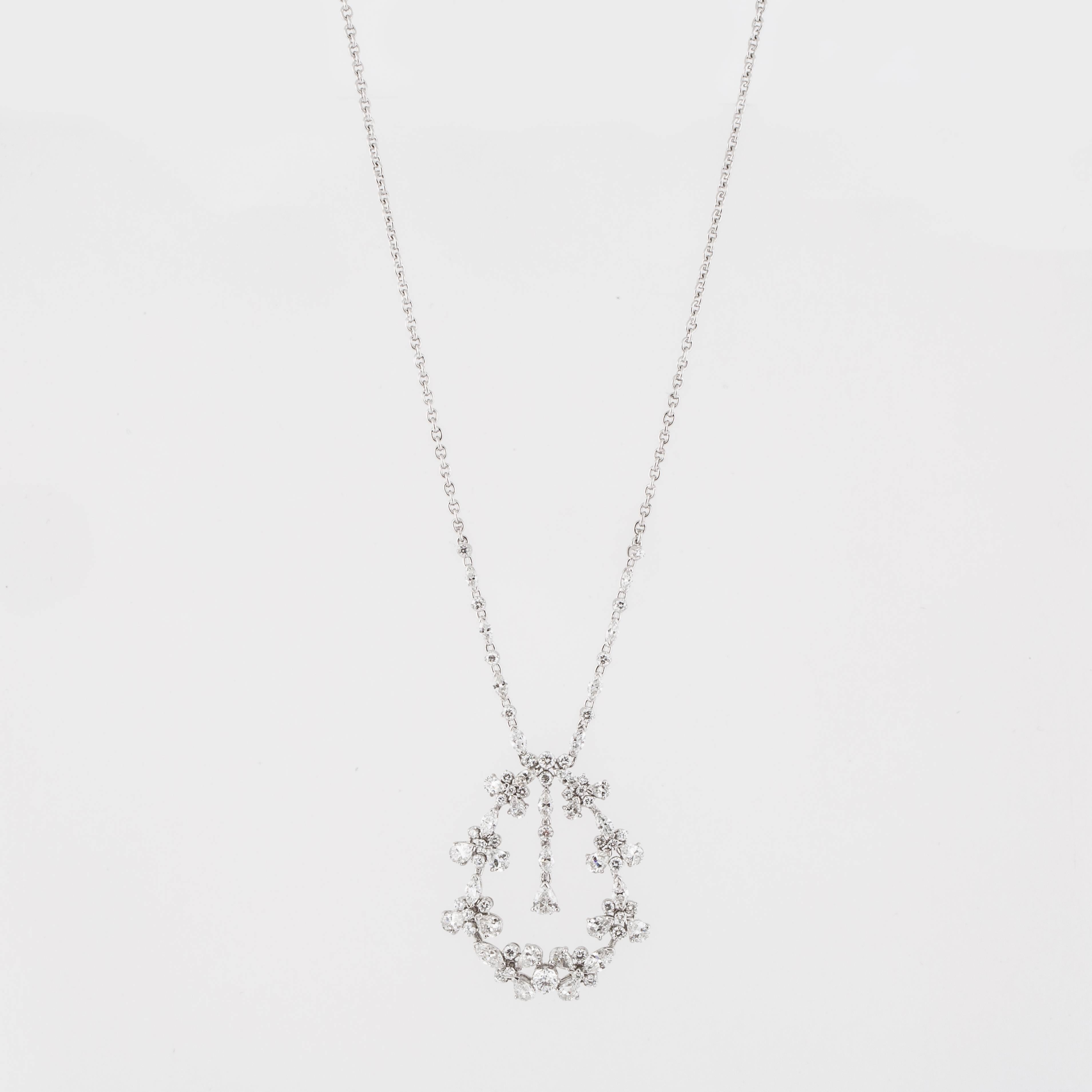 Estate 18K white gold diamond pendant necklace featuring a graduated center garland-inspired drop with tassel on a cable-link chain.  The drop pendant contains forty-six round diamonds, seventeen pear-shape diamonds and eighteen marquise-shape