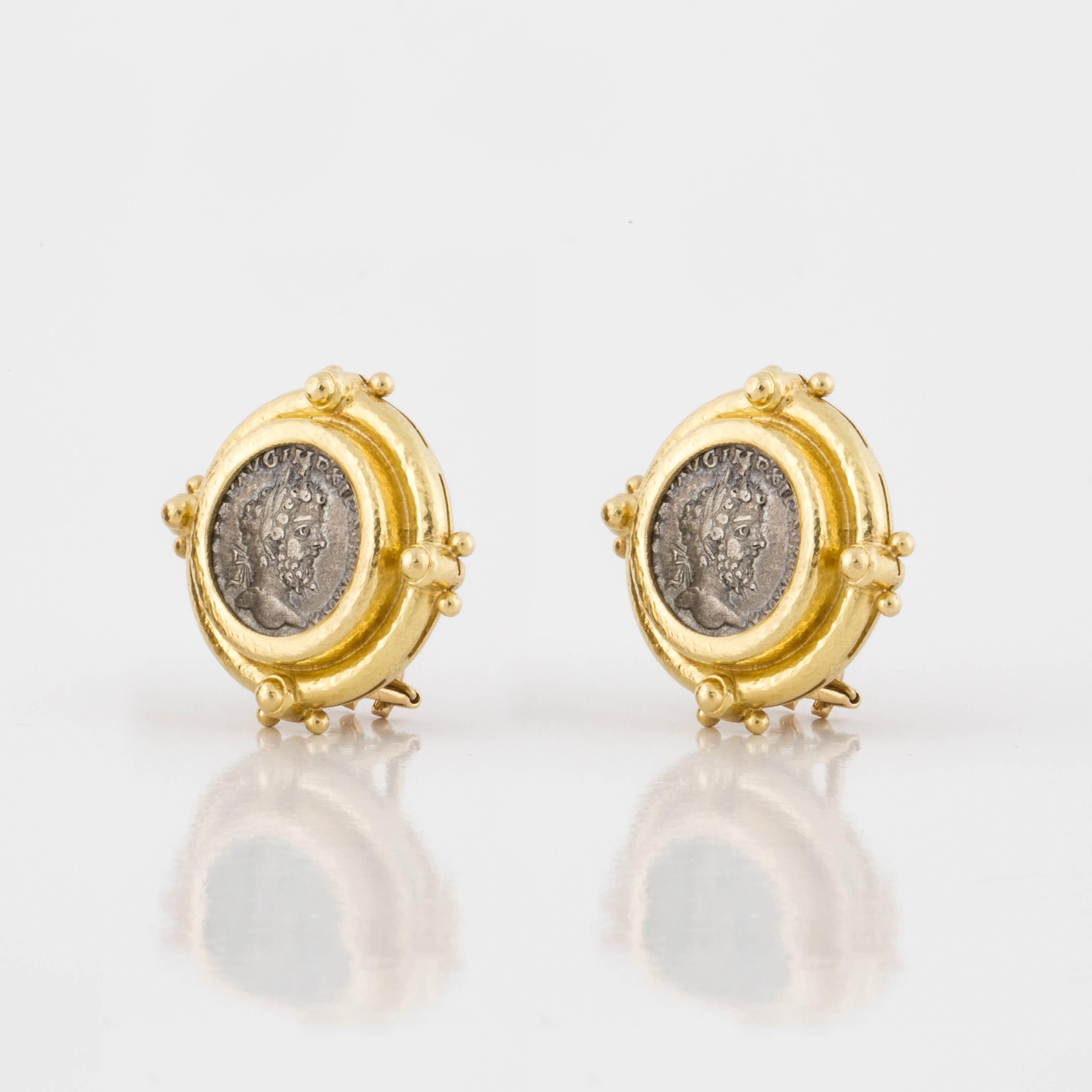 Great looking earrings marked "EL 18K" on the back.  They feature ancient coins framed in 18K yellow gold.  The earrings are clip style with fold down posts.  Measure 1-1/8" across.