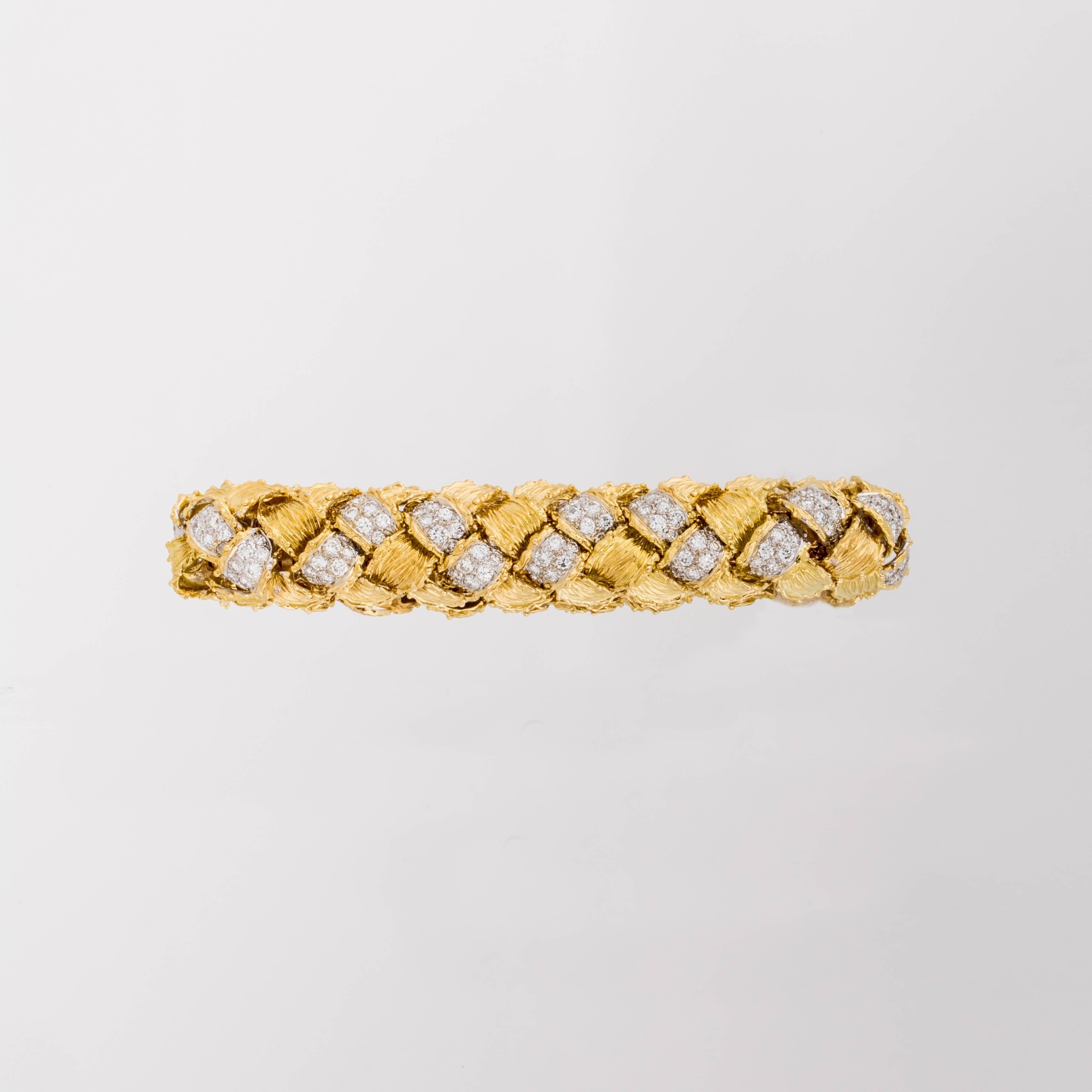 Hammerman Bros. bracelet in 18K yellow gold with round diamonds.  The woven style bracelet is set with 224 round brilliant-cut diamonds totaling 11.45 carats, F-G color and VVS-VS clarity.  Measures 7 1/2 inches long and 5/8 inches wide.  Marked