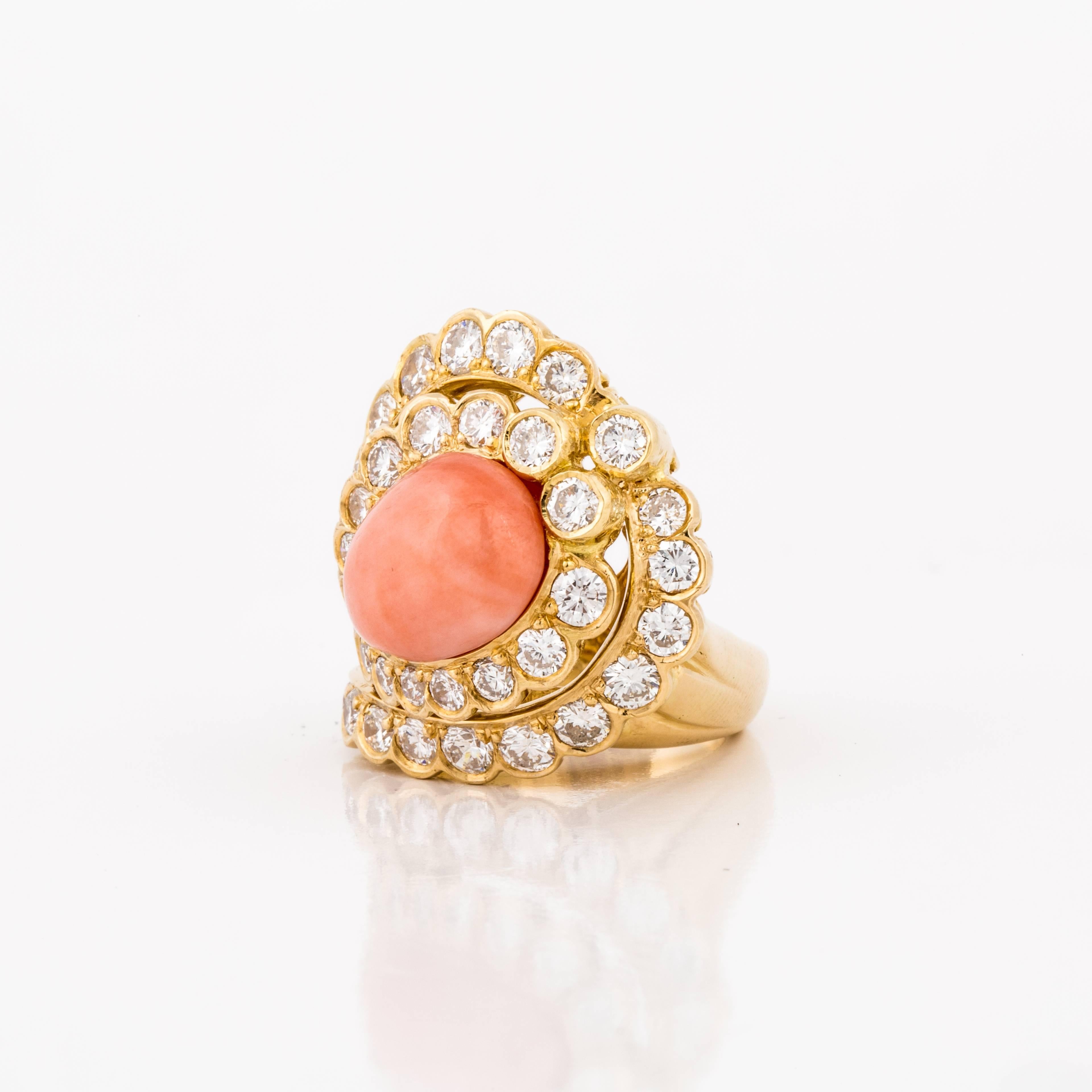 18K yellow gold ring featuring coral framed by round brilliant-cut diamonds.  The diamonds total 3.25 carats, F-H color and VS1-SI1 clarity.  The presentation area is 1 1/8 inch by 1 inch.  The ring is currently a size 6 and may be re-sized.