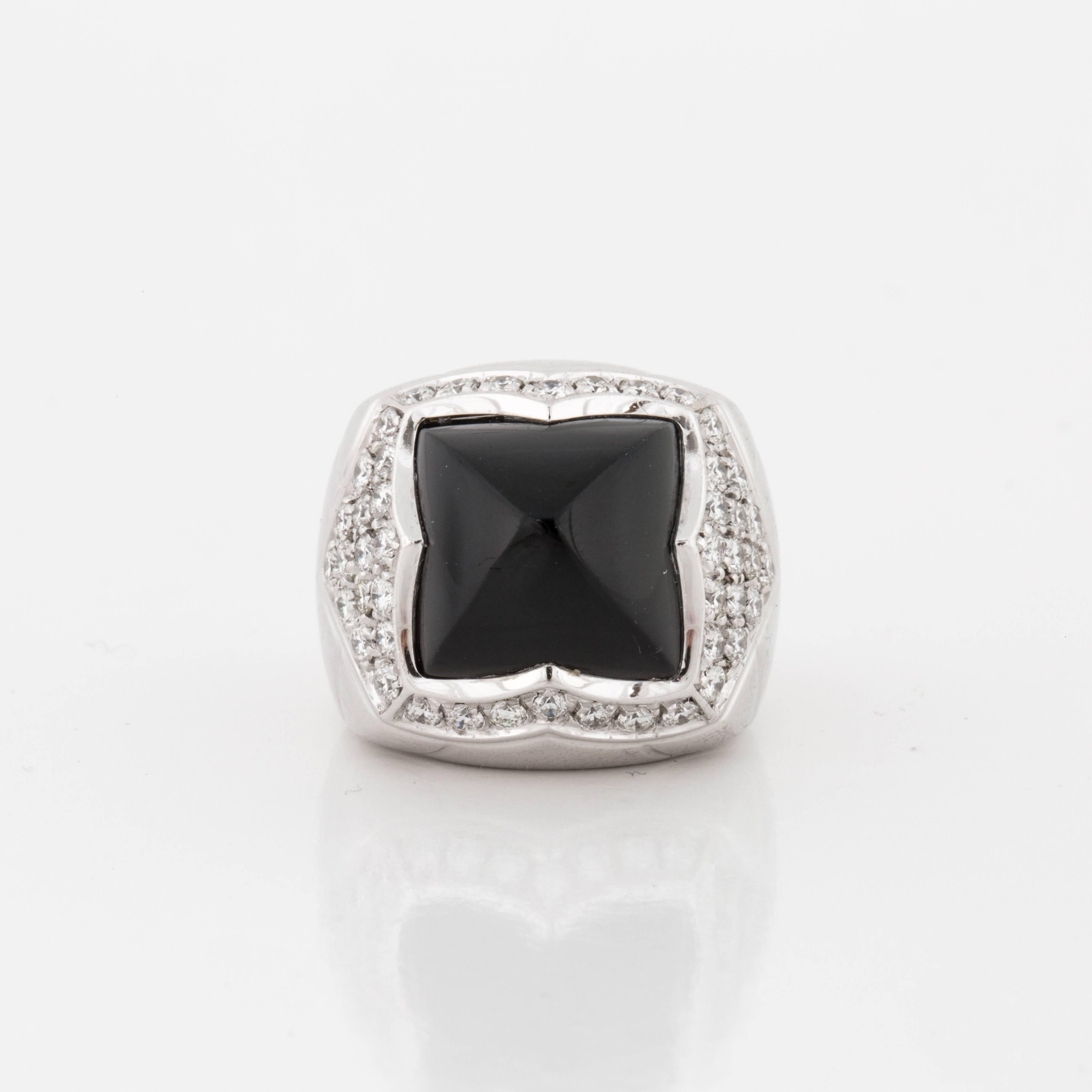 Bulgari Pyramid ring in 18K white gold featuring onyx accented by round diamonds.  There are 46 round diamonds that total 1.35 carats, F-G color and VVS2-VS1 clarity.  Presentation area measures 3/4 inches by 5/8 inches by 1/2 inch deep.  Marked