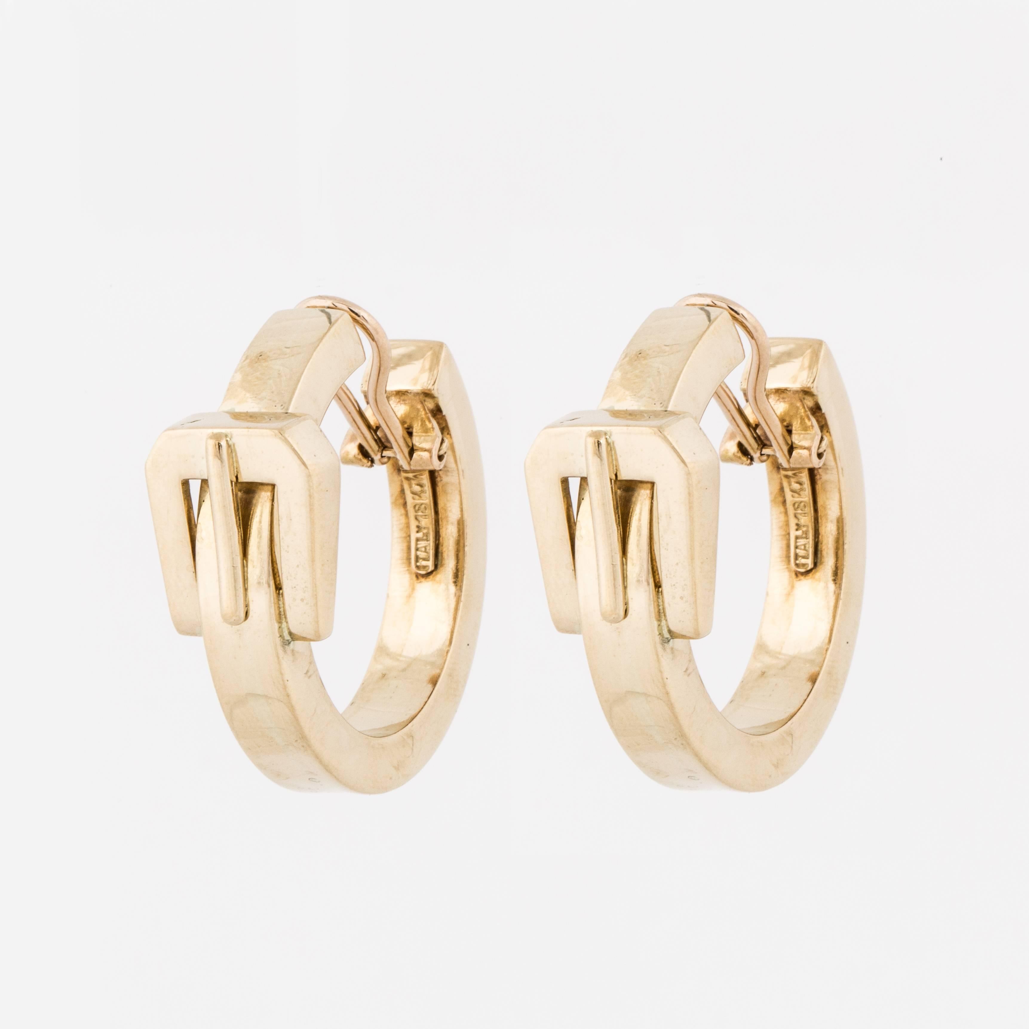 18K yellow gold high polish hoop earrings with a belt buckle motif at the top.  Length of earring is 1 1/2 inches, width at the buckle is 1/2 inch and the hoop measures 1/4 inch wide.   