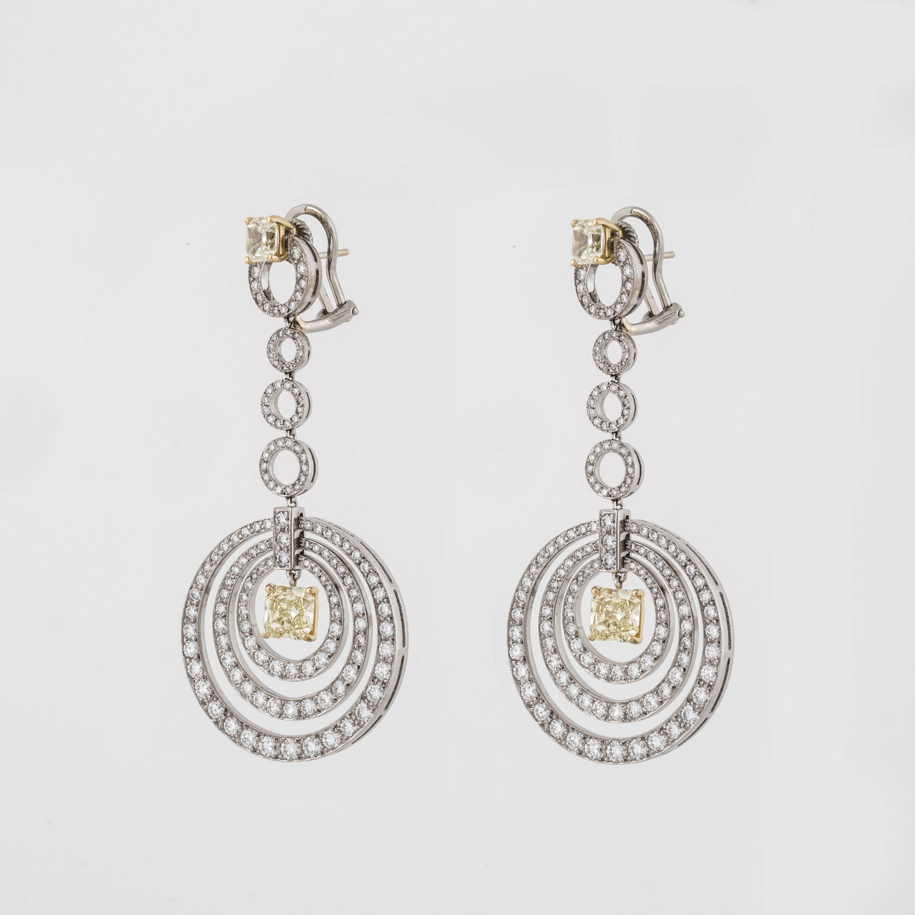 Graff earrings composed of 18K white and yellow gold with white and yellow diamonds.  The concentric circle design features 266 round brilliant-cut diamonds that total 6 carats, E-F color and VVS2-VS1 clarity.  There are four radiant-cut yellow