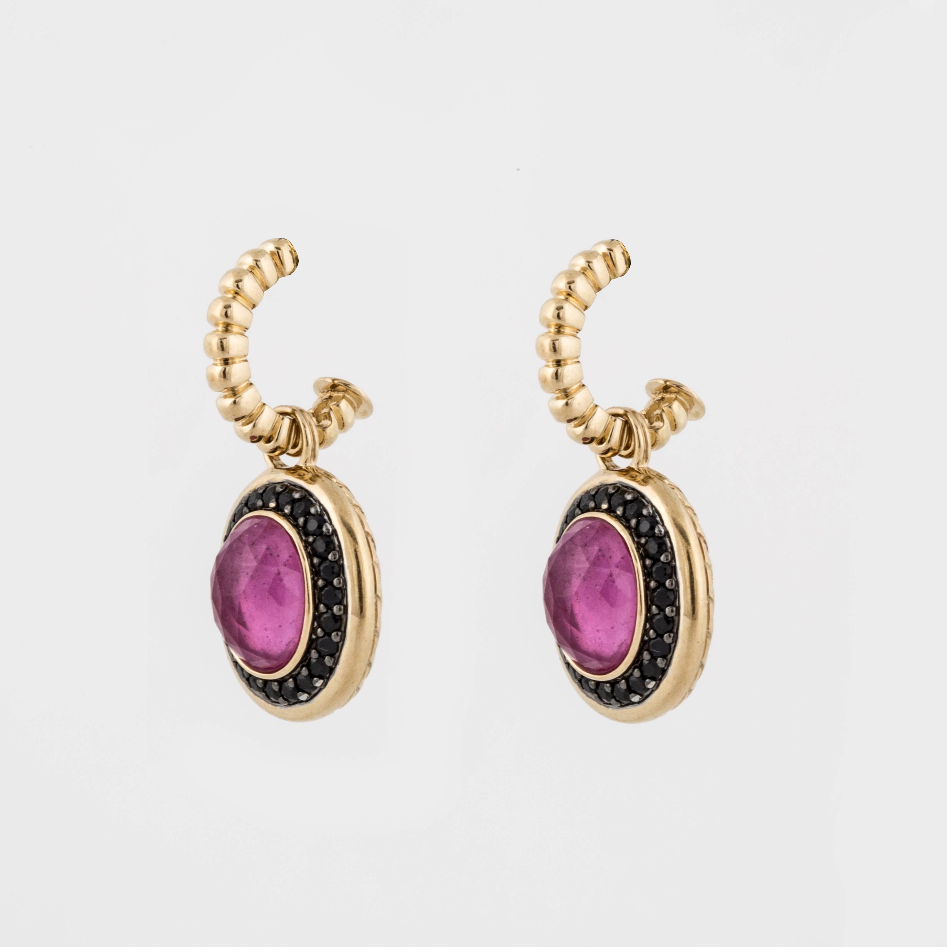 Yellow gold and silver earrings marked "JH 18K" on the back.  There are 48 (forty eight) round black sapphires totaling 1.20 carats.  The black sapphires are set in silver.  The 2 (two) oval stones are faceted pink sapphire doublets. 