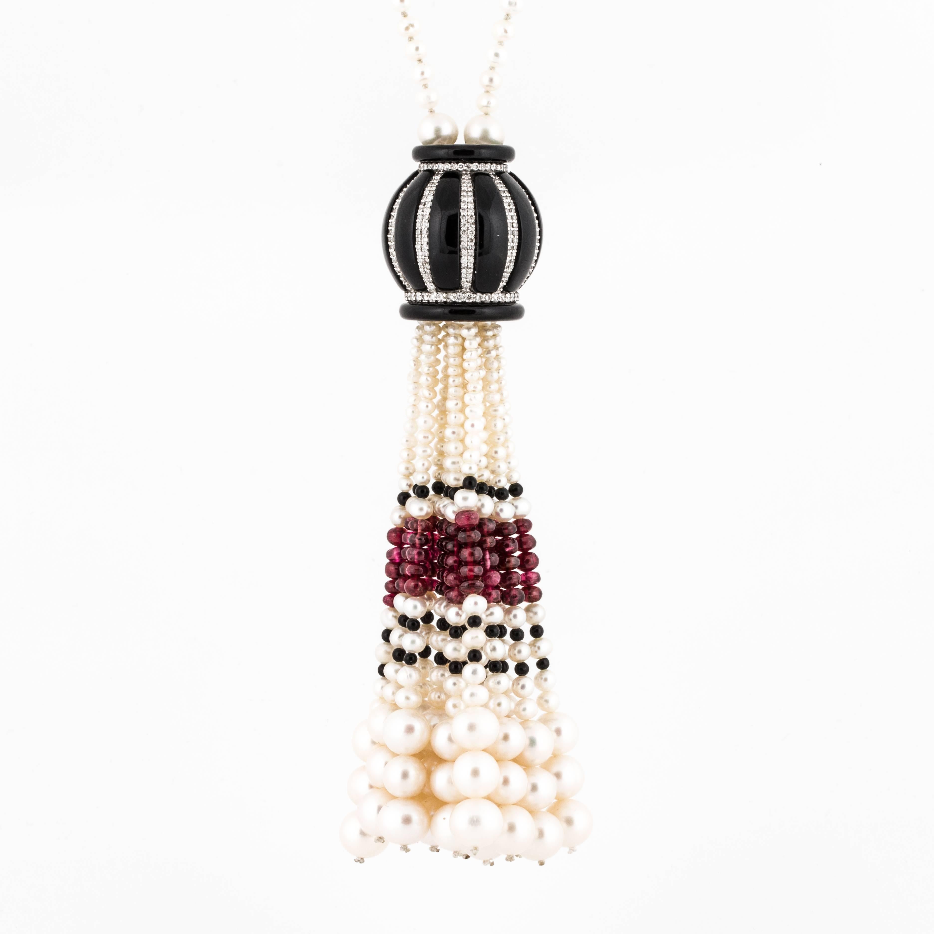 Wonderful necklace featuring cultured pearls, onyx, rubies, coral and diamonds. Total carat weight of the diamonds is 3.10 and they are H-I in color and SI-1 in clarity.  The large tassel is 4.5 long and the necklace portion measures 32".  This