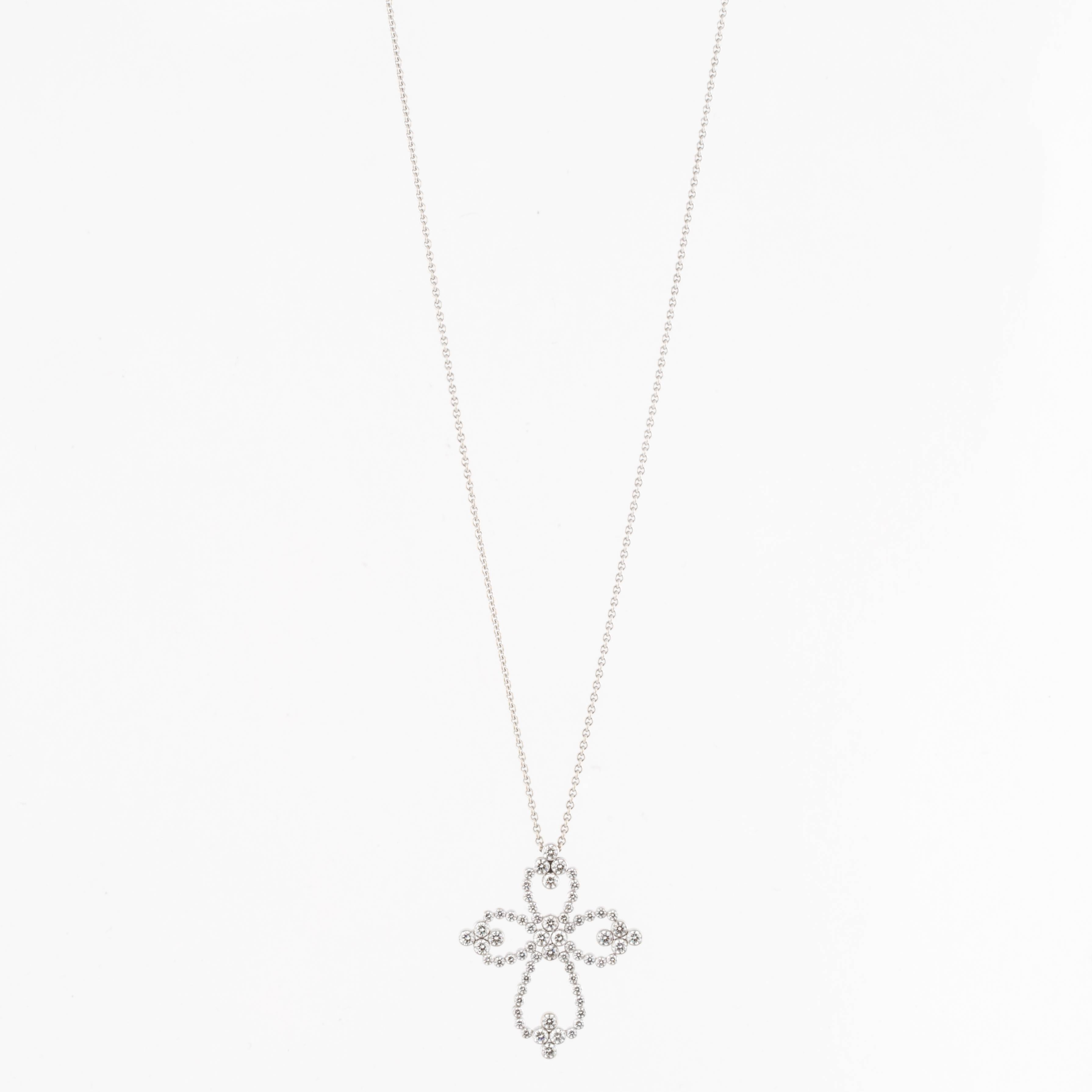 Diamond cross pendant necklace composed of 18K white gold. There are fifty-two (52) round diamonds that total 1.75 carats; F-H color and VS1-SI2 clarity.  The chain measures 16 inches long.  The cross measures 1 1/2 inches long and 1 3/16 inches