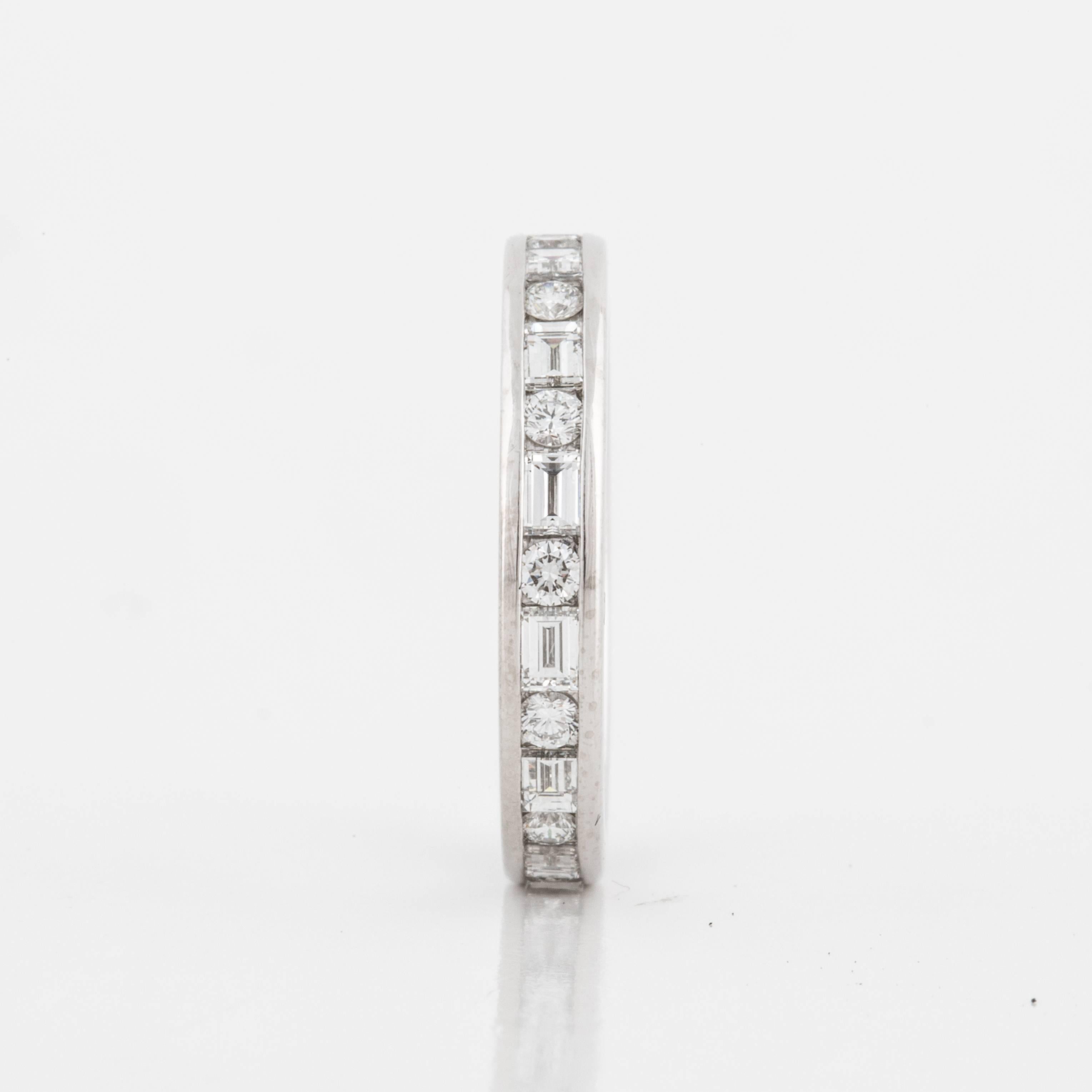 Tiffany & Co. platinum diamond eternity band featuring channel-set alternating round and baguette diamonds.  There are thirteen round brilliant-cut diamonds weighing 0.65 carats and thirteen baguette diamonds weighing 1.05 carats.  All diamonds are