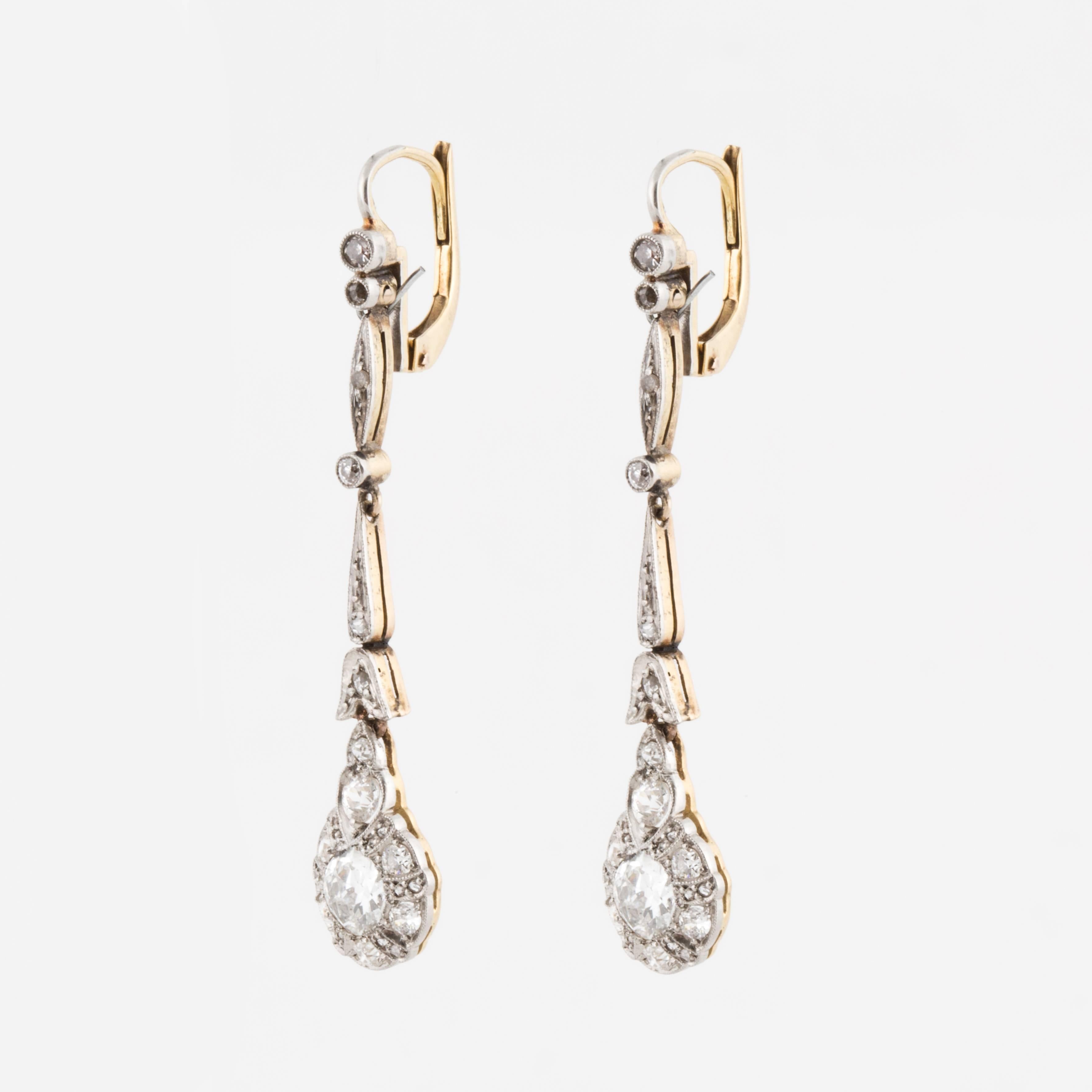 Diamond drop earrings made in both platinum and 18K yellow gold, set with old European-cut and rose-cut diamonds. The total diamond carat weight is 1.79, I-L color and VS1-SI2 clarity.  Measure 1-7/8 inches long and 3/8 inches wide at the bottom.